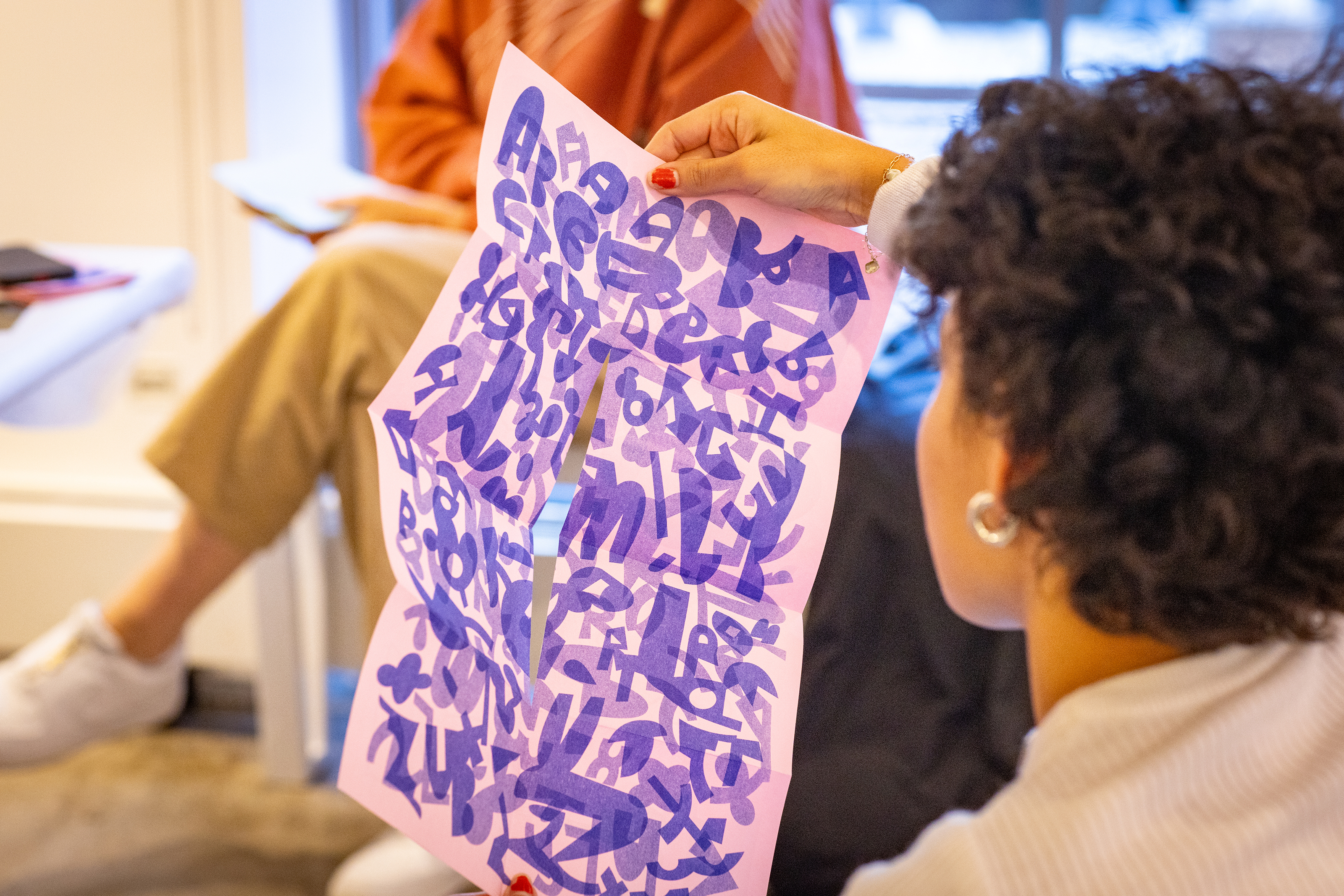 a purple and pink zine unfolds into a print