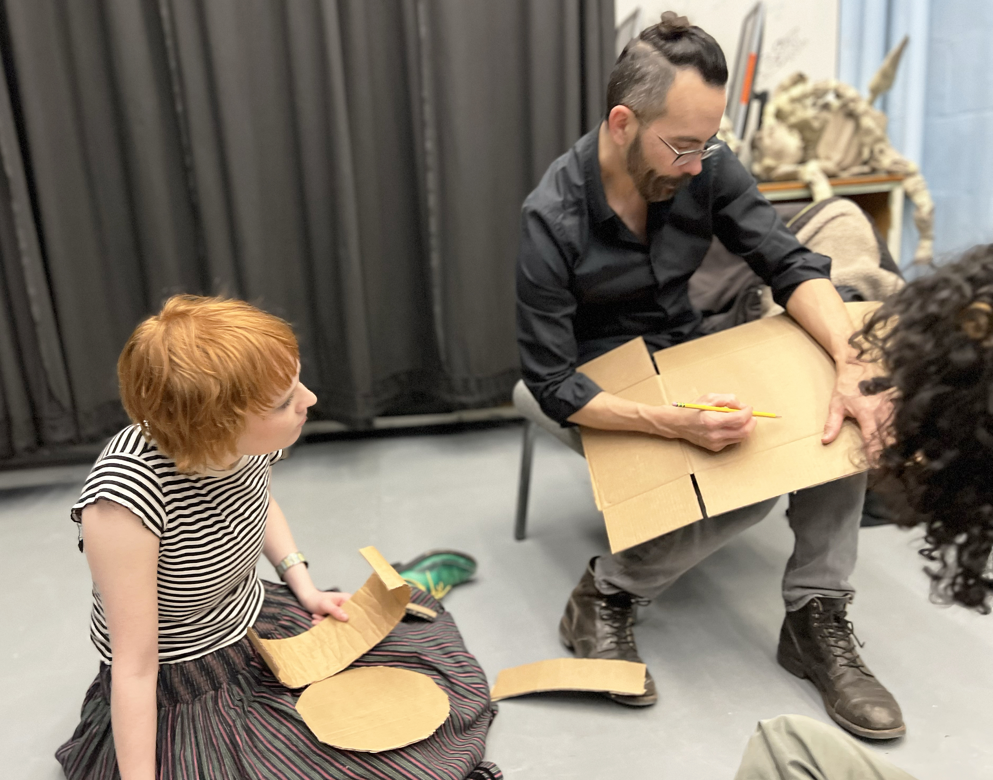 visiting puppeteer Tom Lee provides advice about using cardboard and papier-mache