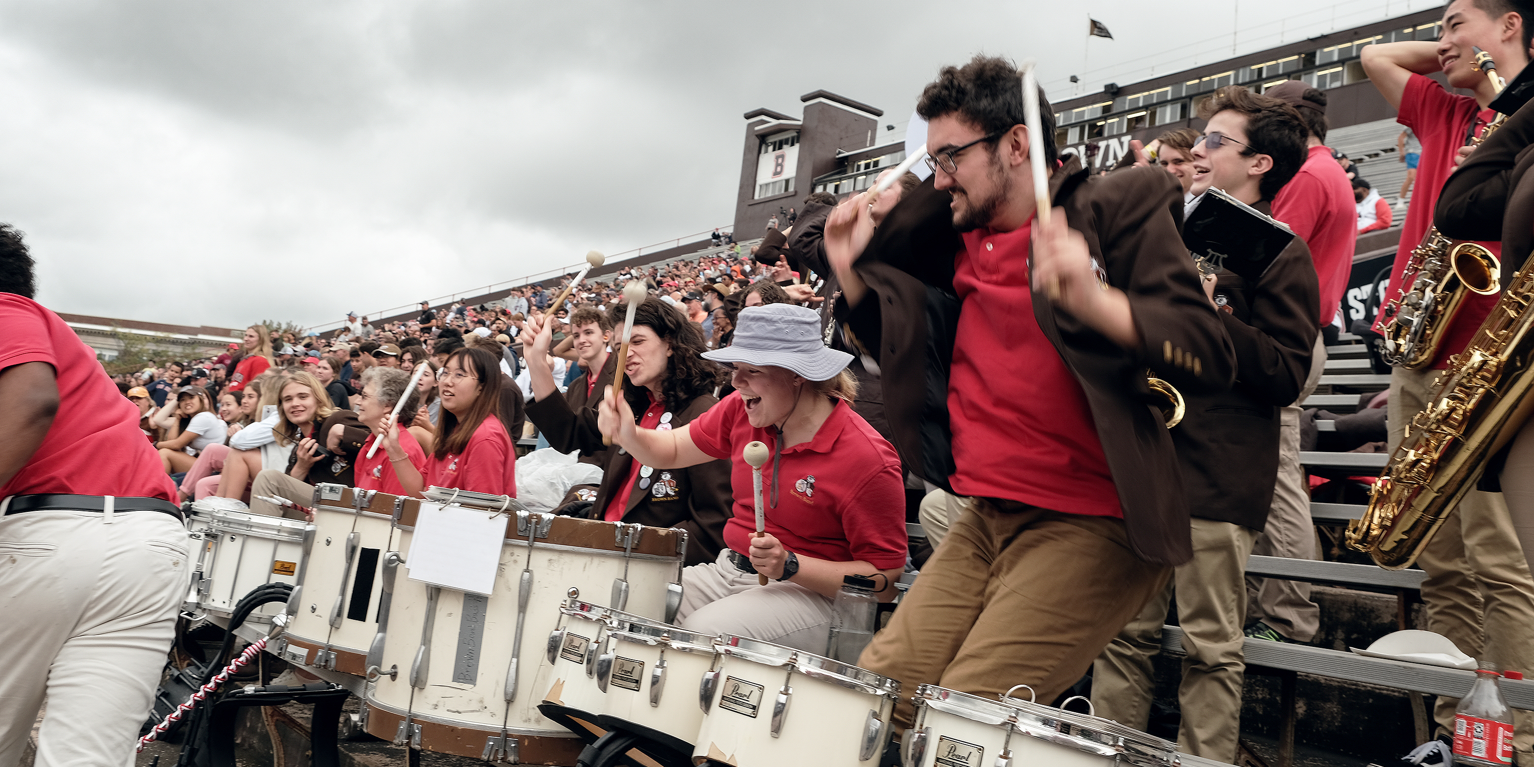 Brown's marching band in the bleachers on a cloudy day
