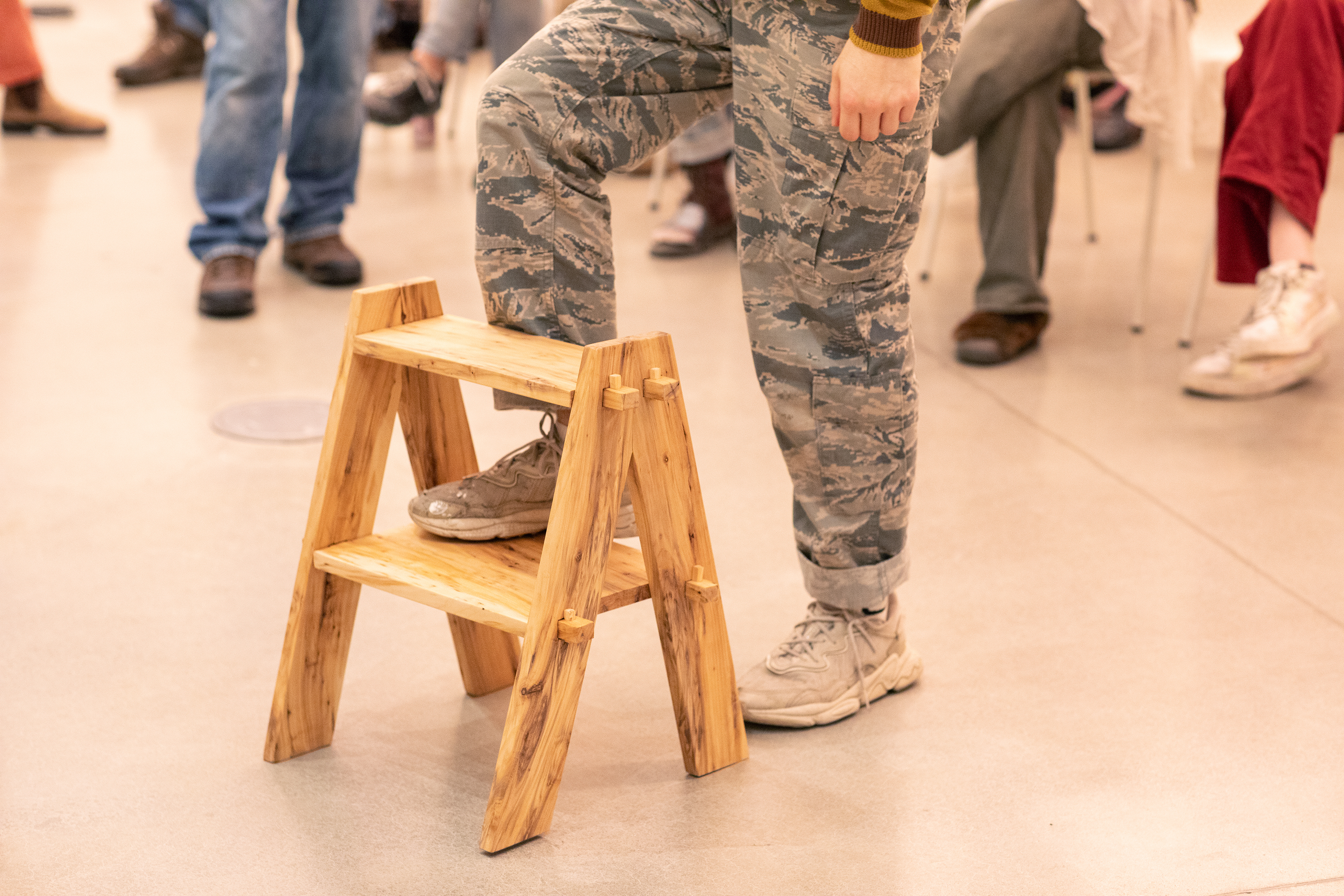 a student tests a willow step-stool