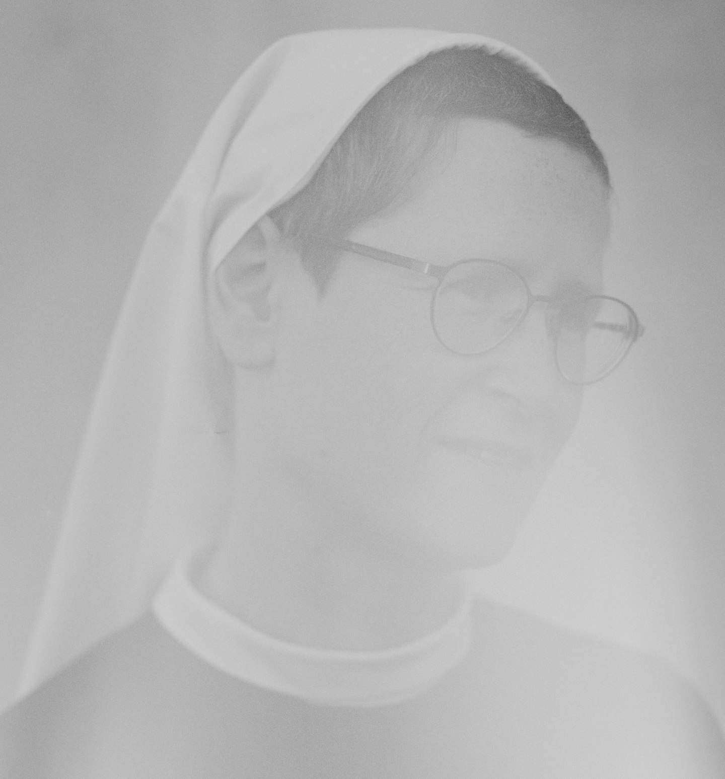 hazy black and white photo of a Cistercian nun