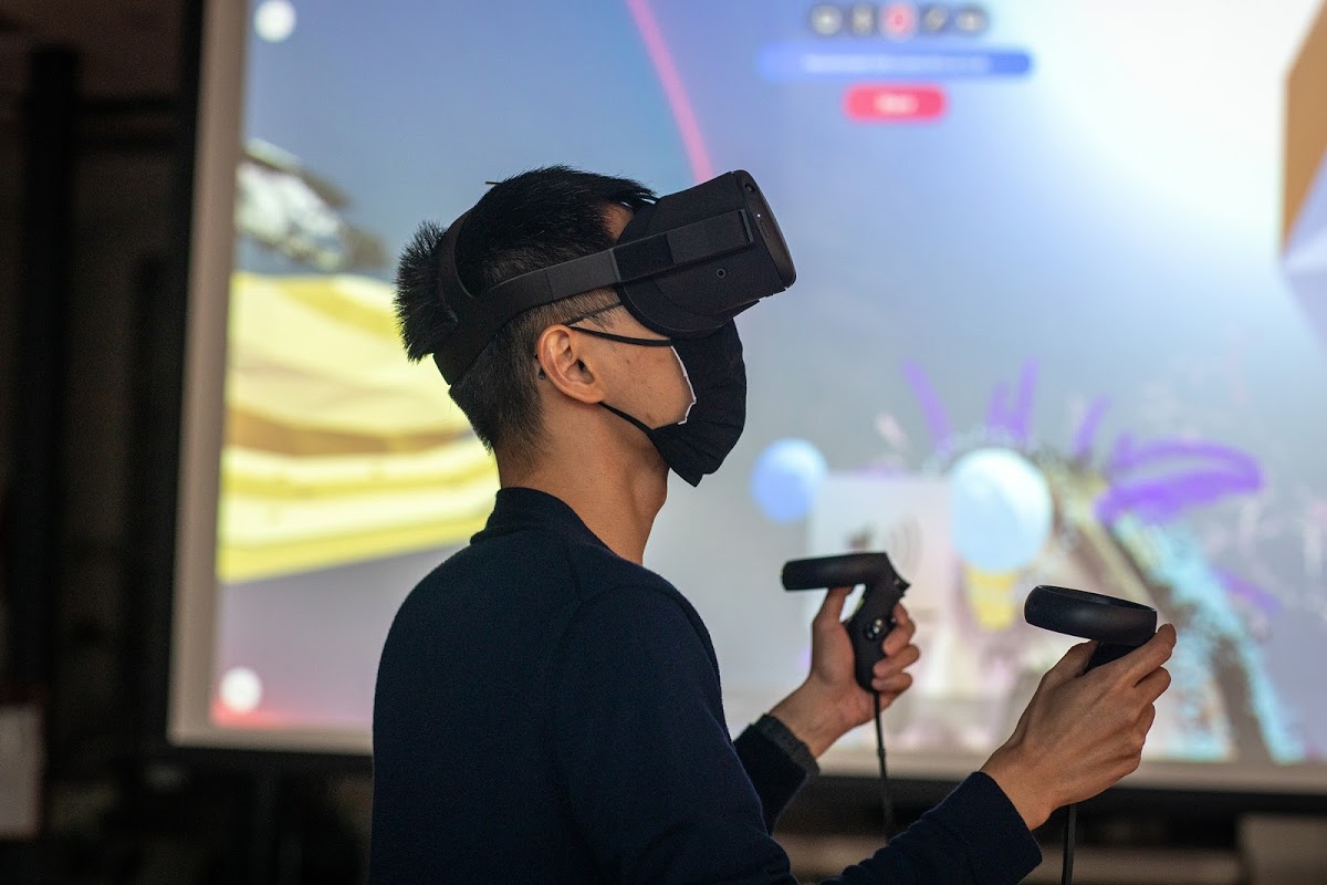 Student using virtual reality headset and controllers