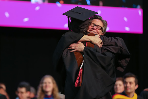Professor of Graphic Design Bethany Johns gives a new graduate a hug