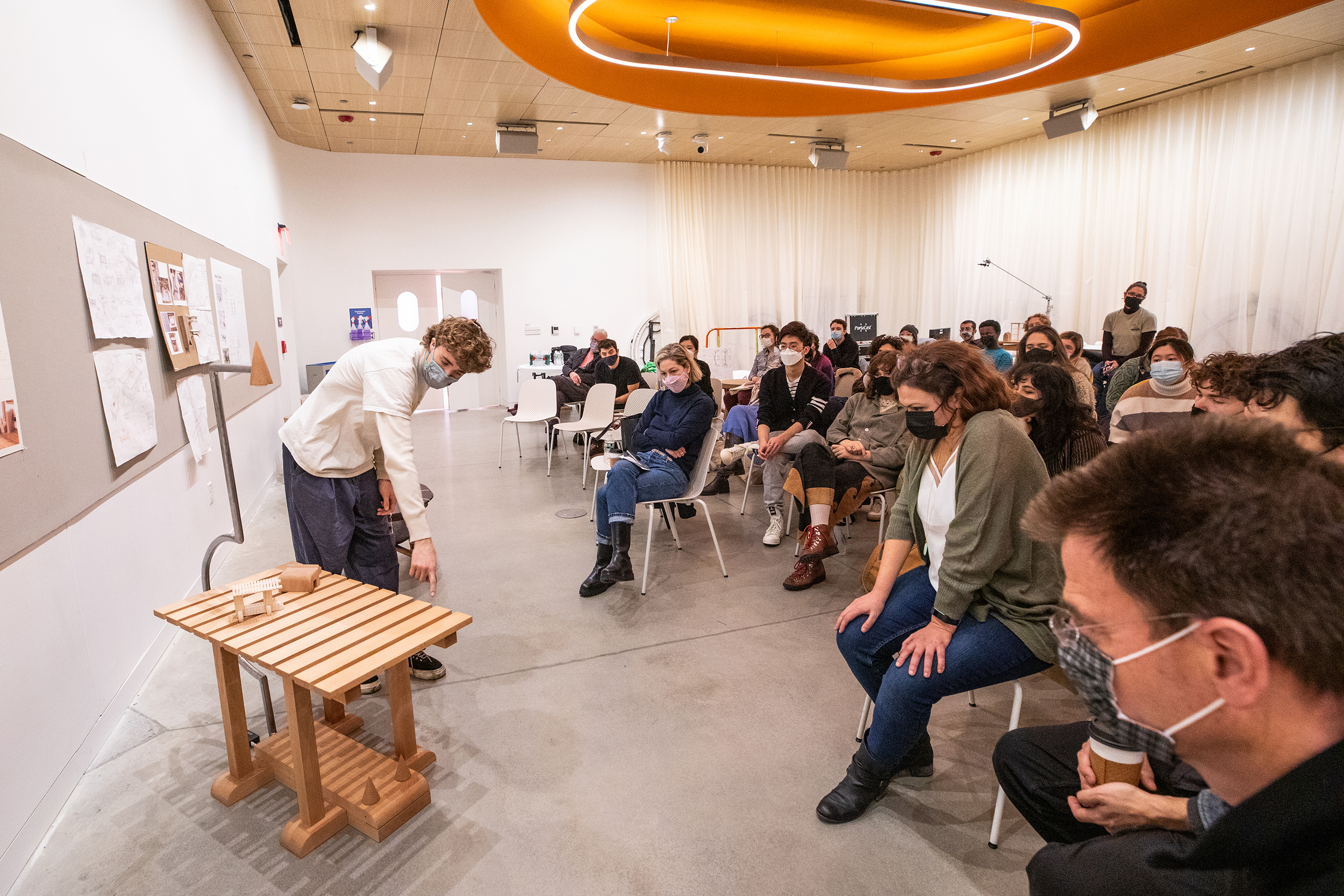 a crowded room at a Furniture Design crit