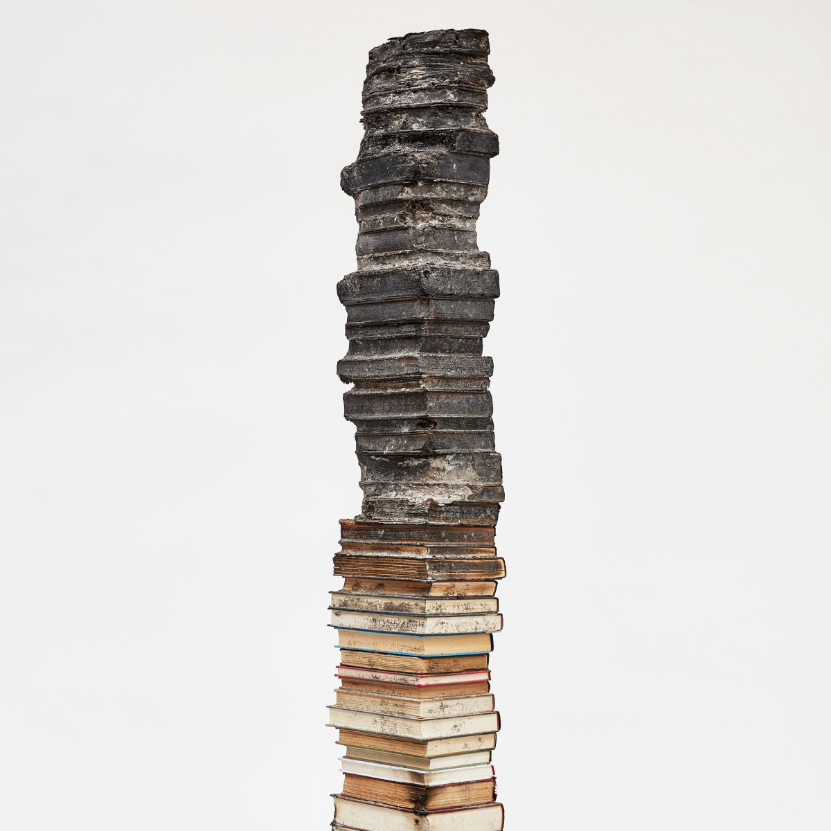 One of Jared's stacks of books is charred from the top down