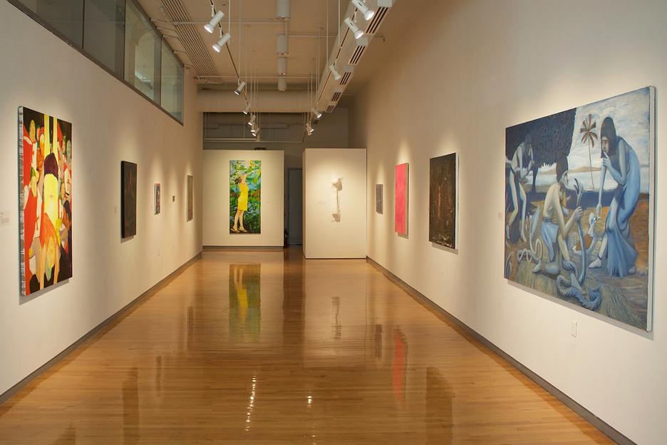 paintings lining exhibition walls on opposite sides of the Sol Koffler Gallery