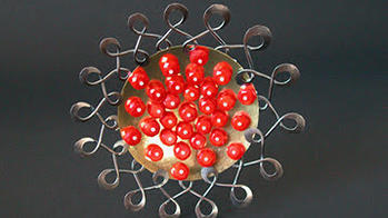 Abstract metal plate with bright red balls in the center