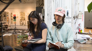 two students drawing during drawing marathon.