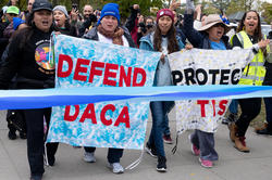 Protesters with signs supporting Deferred Action for Childhood Arrivals 