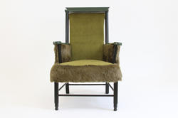 A comfortable armchair embellished with green faux fur