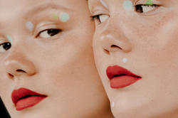 identical models wearing unusual makeup