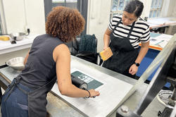 Assistant Professor Juana Estrada Hernandez working with a student on a print
