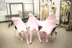 Apparel Design students wearing three-person body suit in studio
