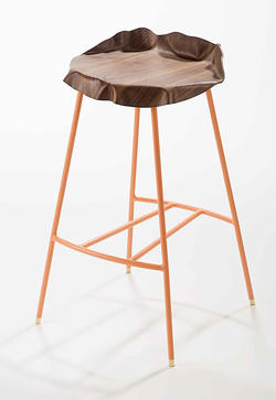 A stool with tree trunk-like wooden seat by Furniture Design alum Hannah Bartlett