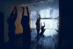 students interact with a light installation