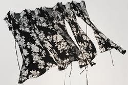 Student artwork made of black fabric with white flowers