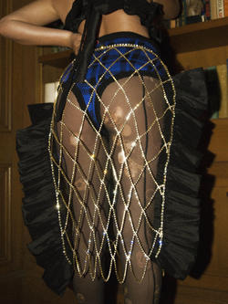 a model wears fishnet stockings and blue-and-black plaid bottoms, designed by Amanda Glickman