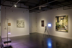 a wide-angle view of photographs, projections and other artworks inside a gallery