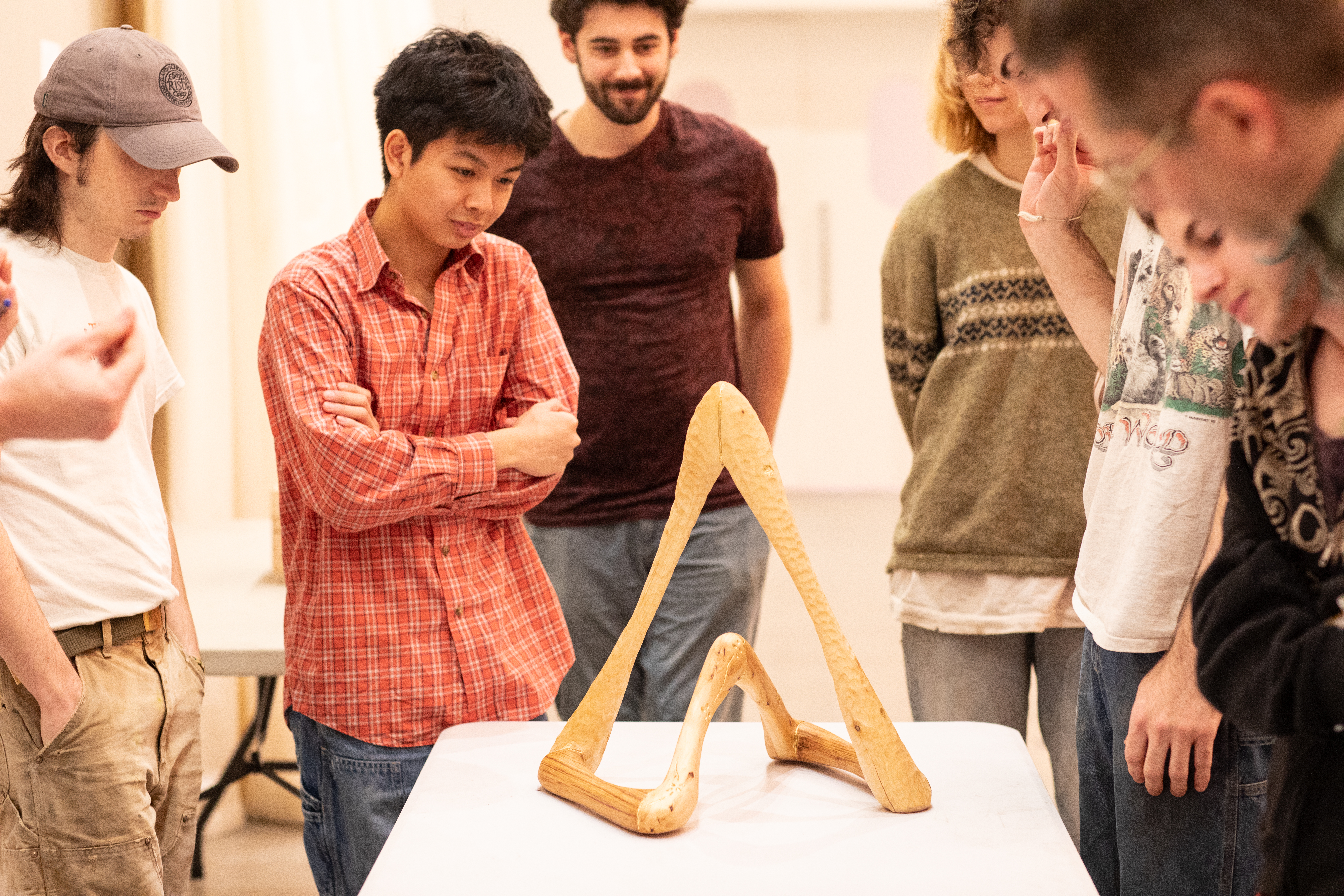 students gather around an abstract piece created by Ethan Howard