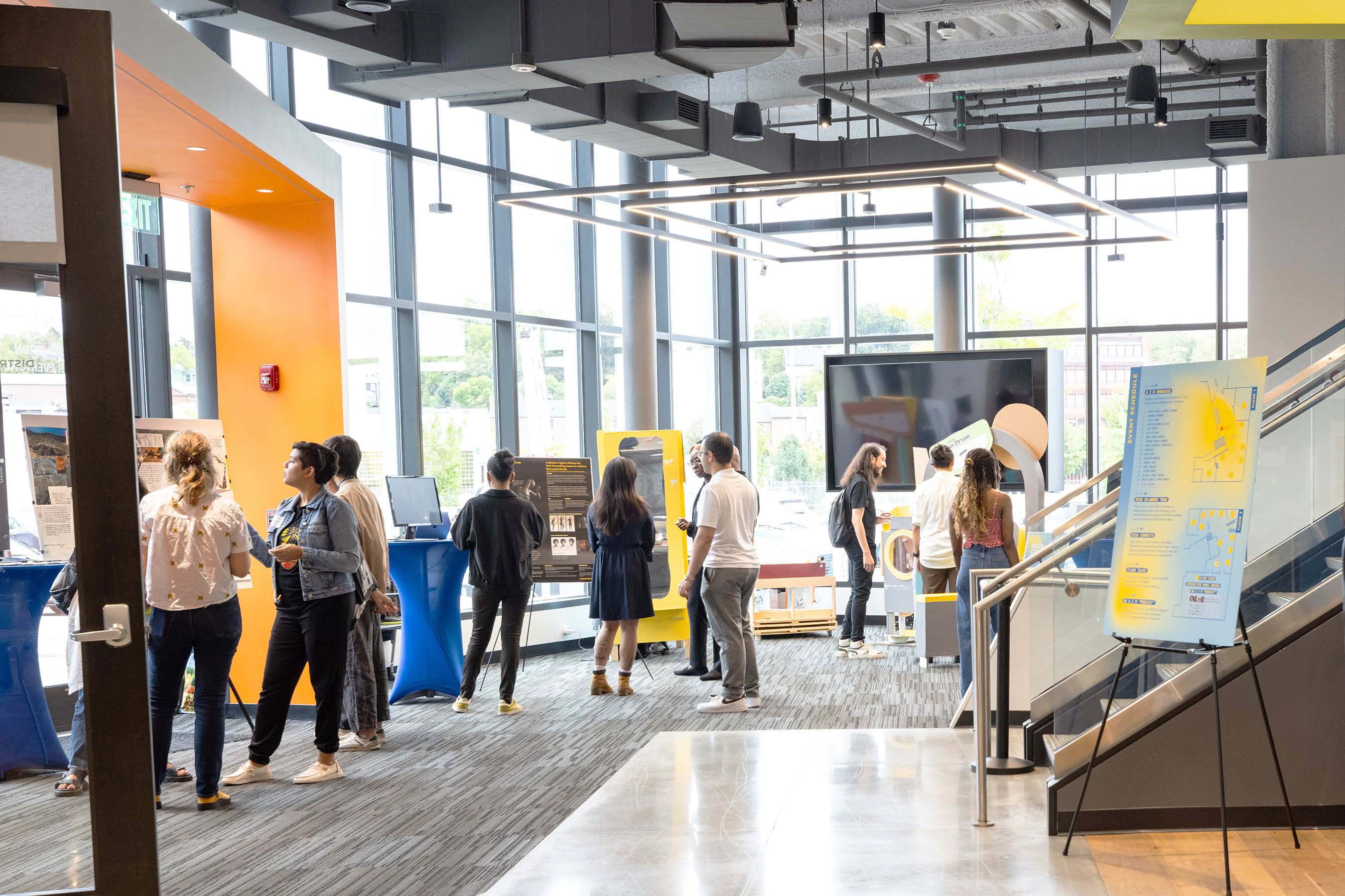 visitors check out projects on view in the lobby