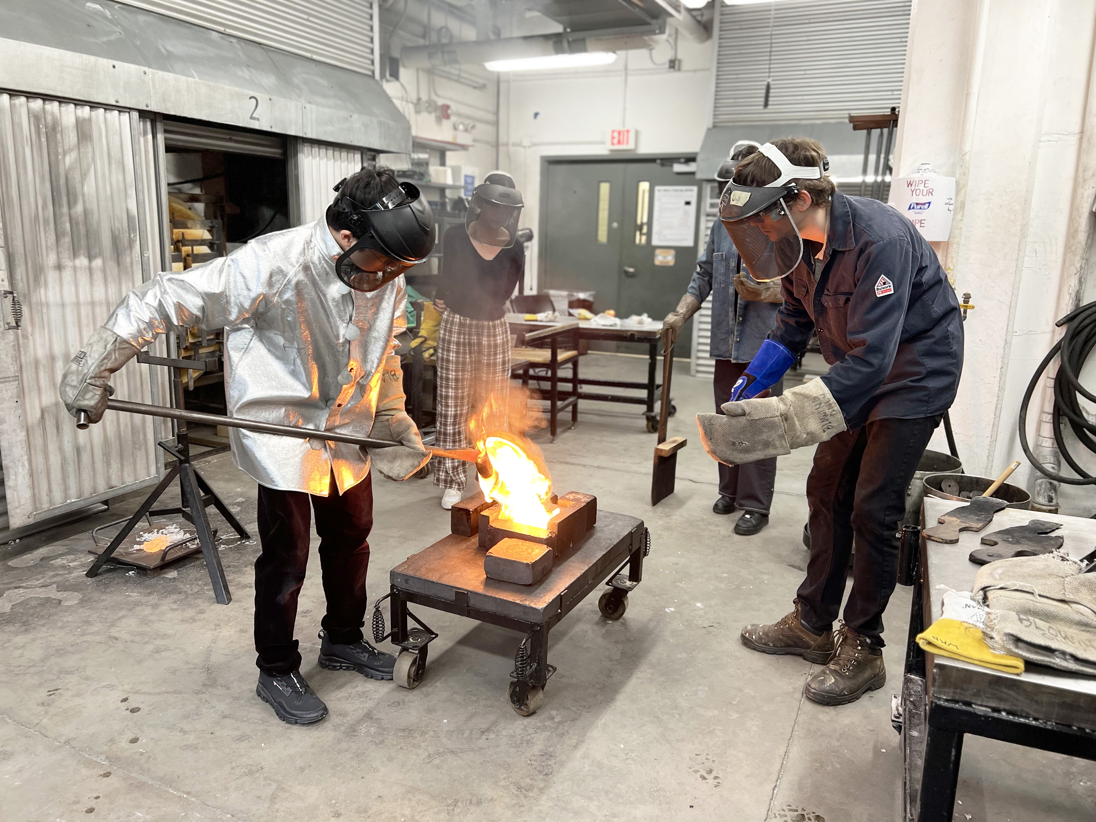 Will Beattie and students collaborating in the hot shop