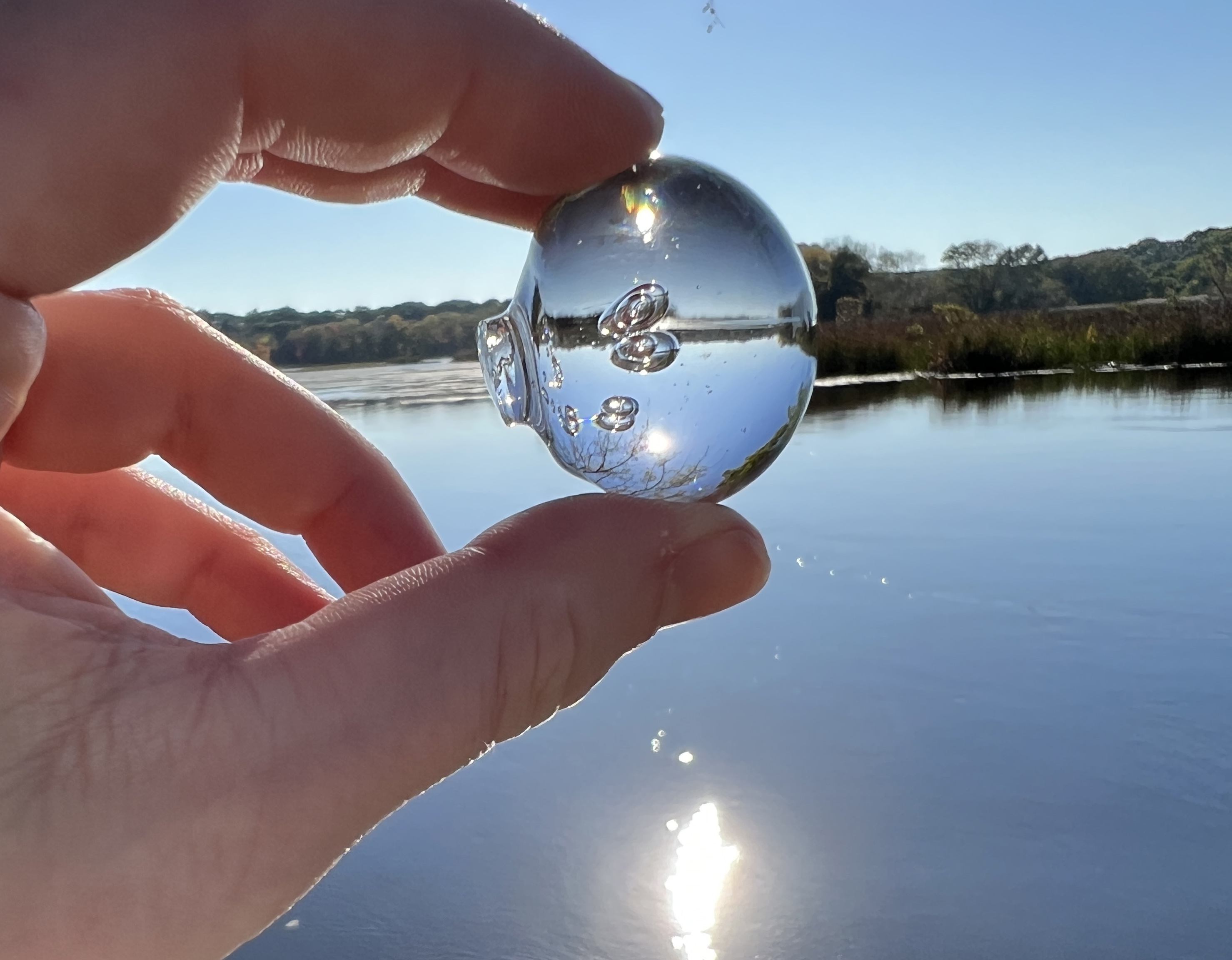 close-up of a glass bead reflecting two images of the sun at once