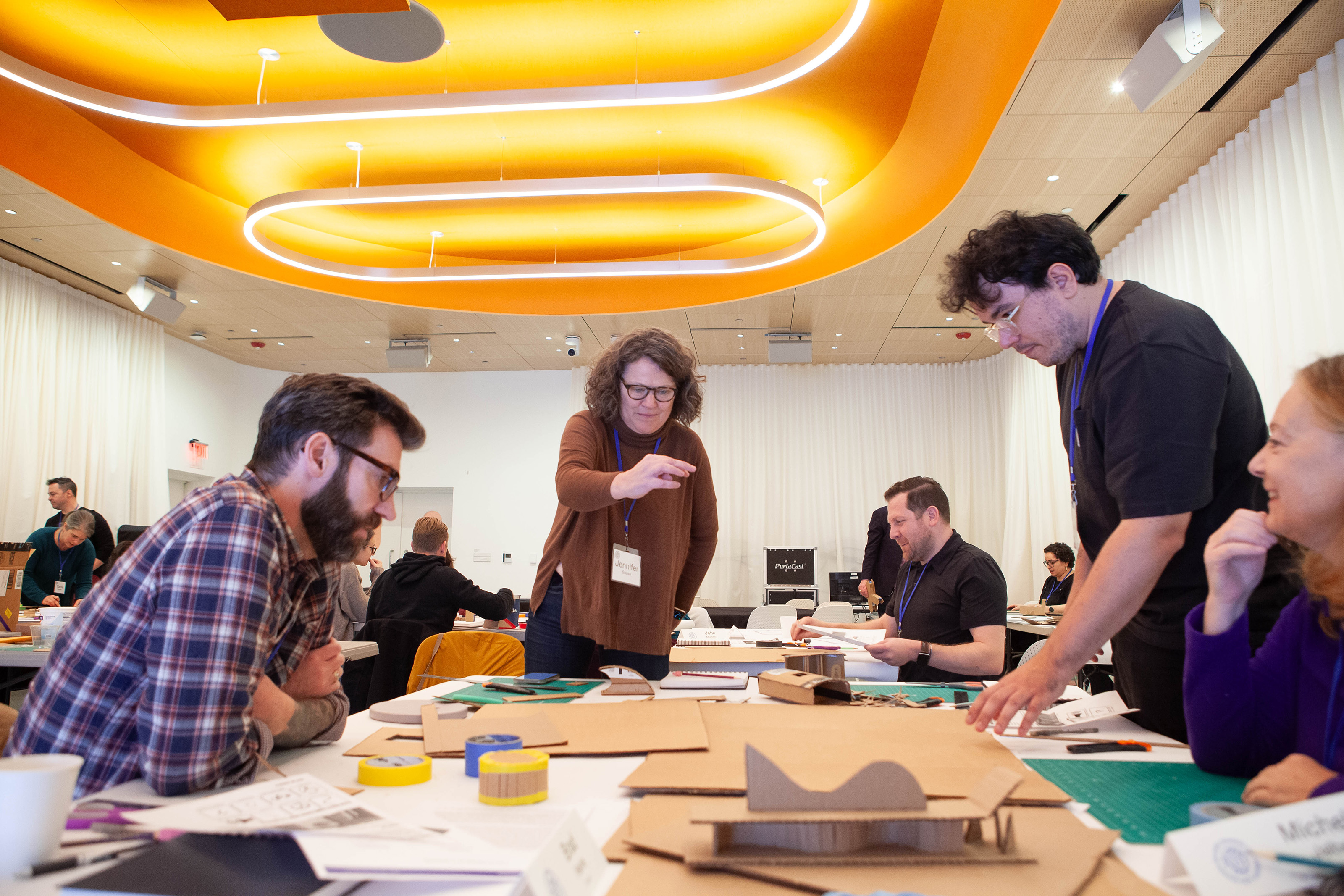 participants work with cardboard in a creativity session