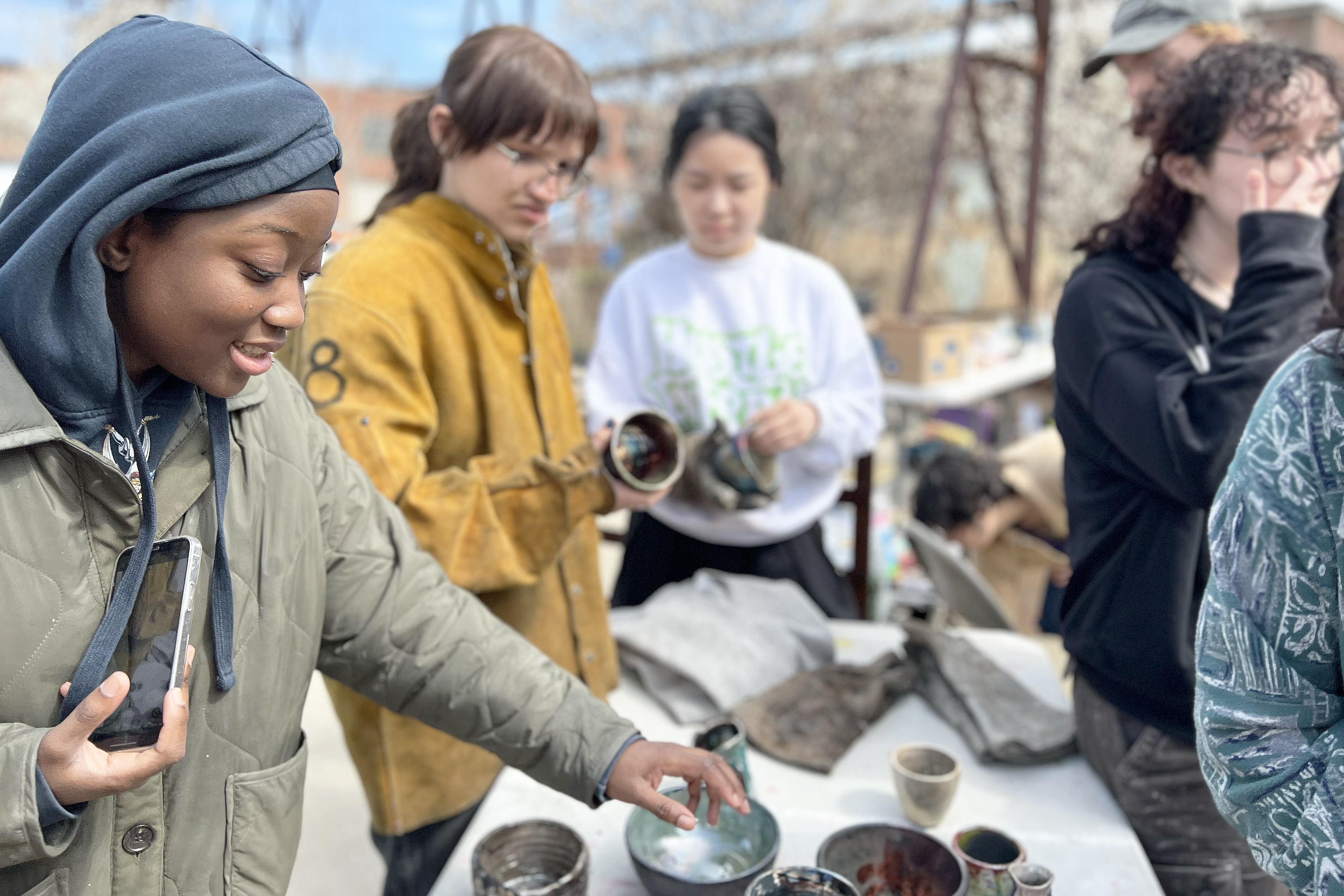 students admire their just-fired ceramic bowls at the steel yard