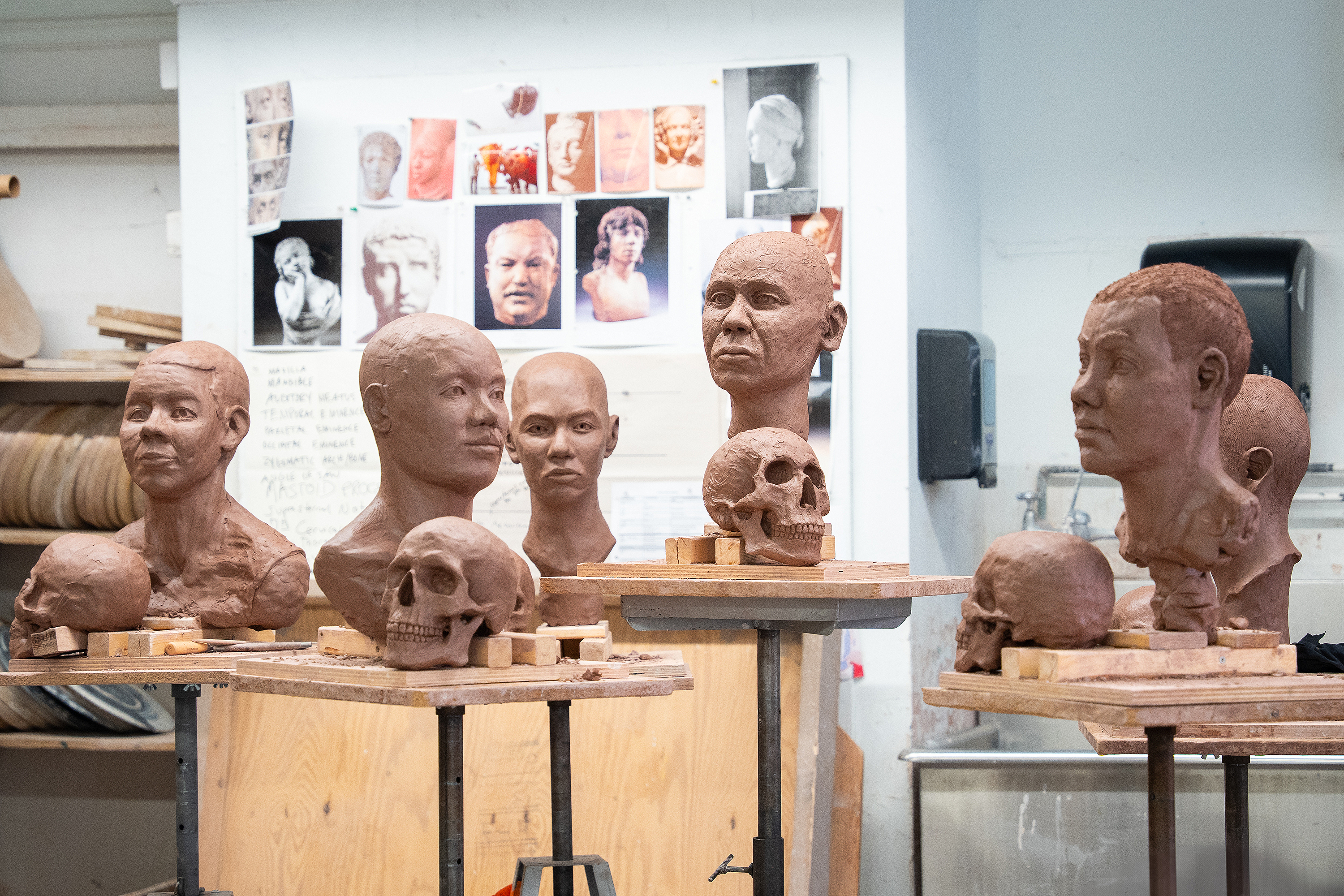 completed portraits and skulls on display