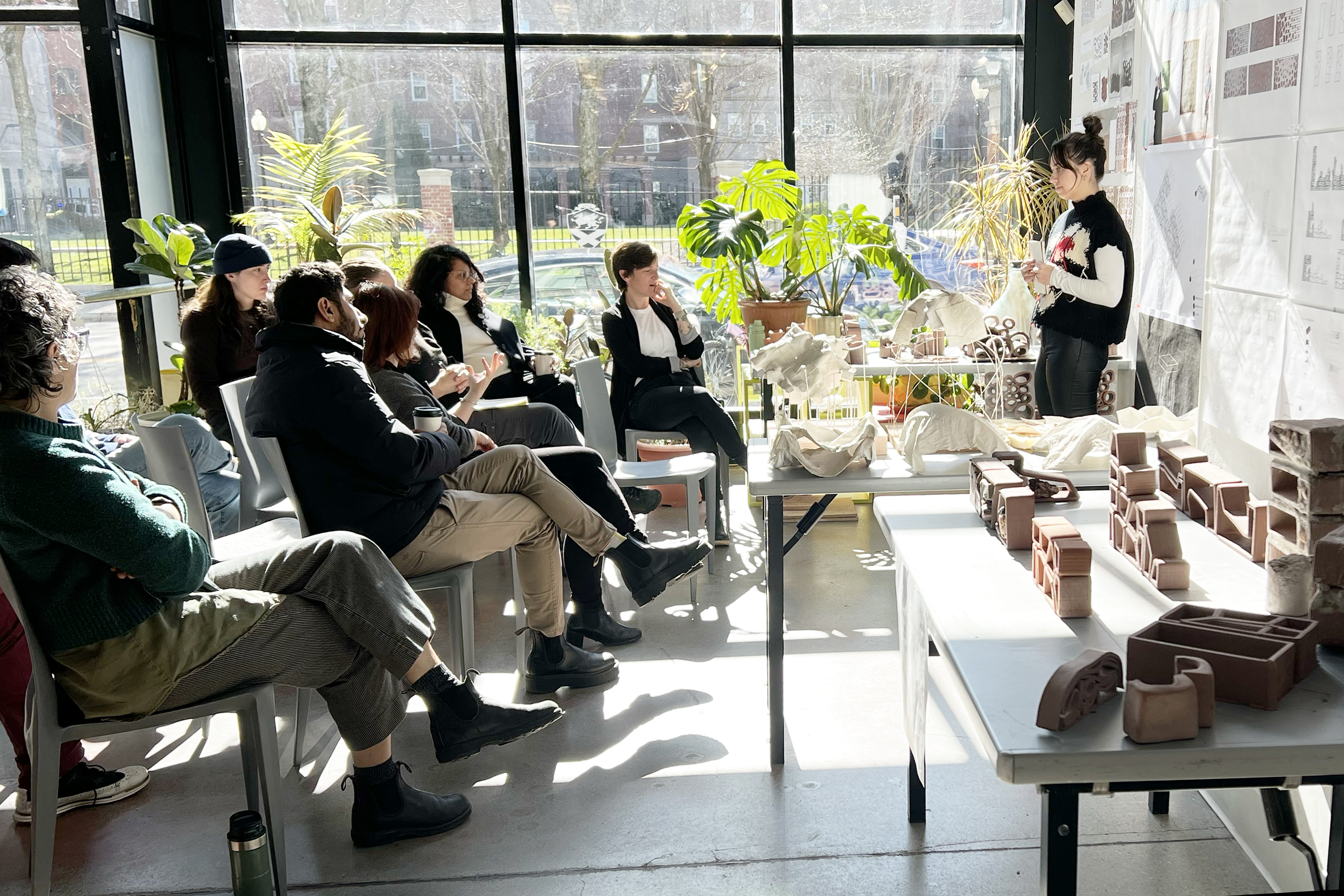 a student presents her research at a midterm crit