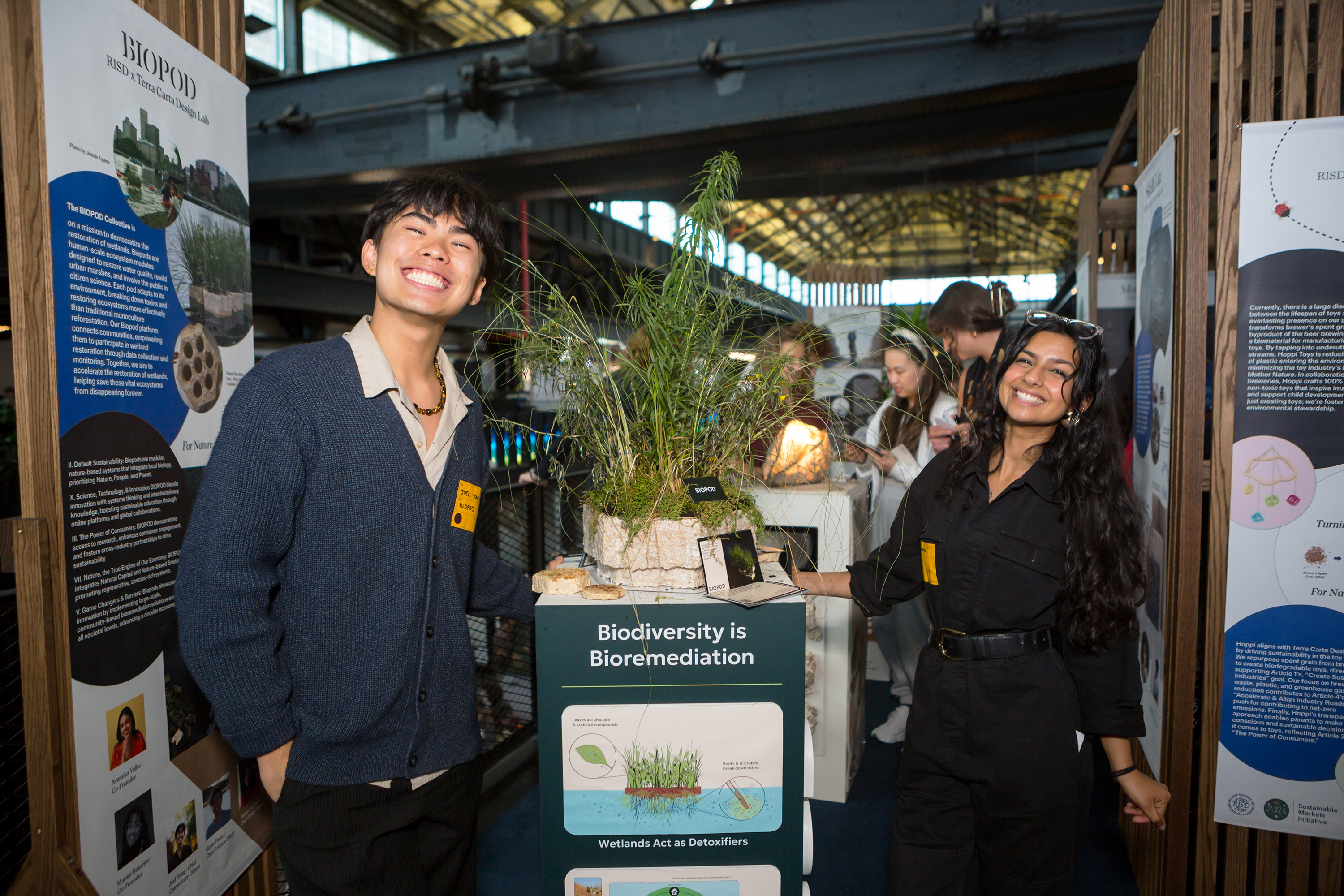 Joel Yong and Avantika Velho show off their Biopods project to event visitors