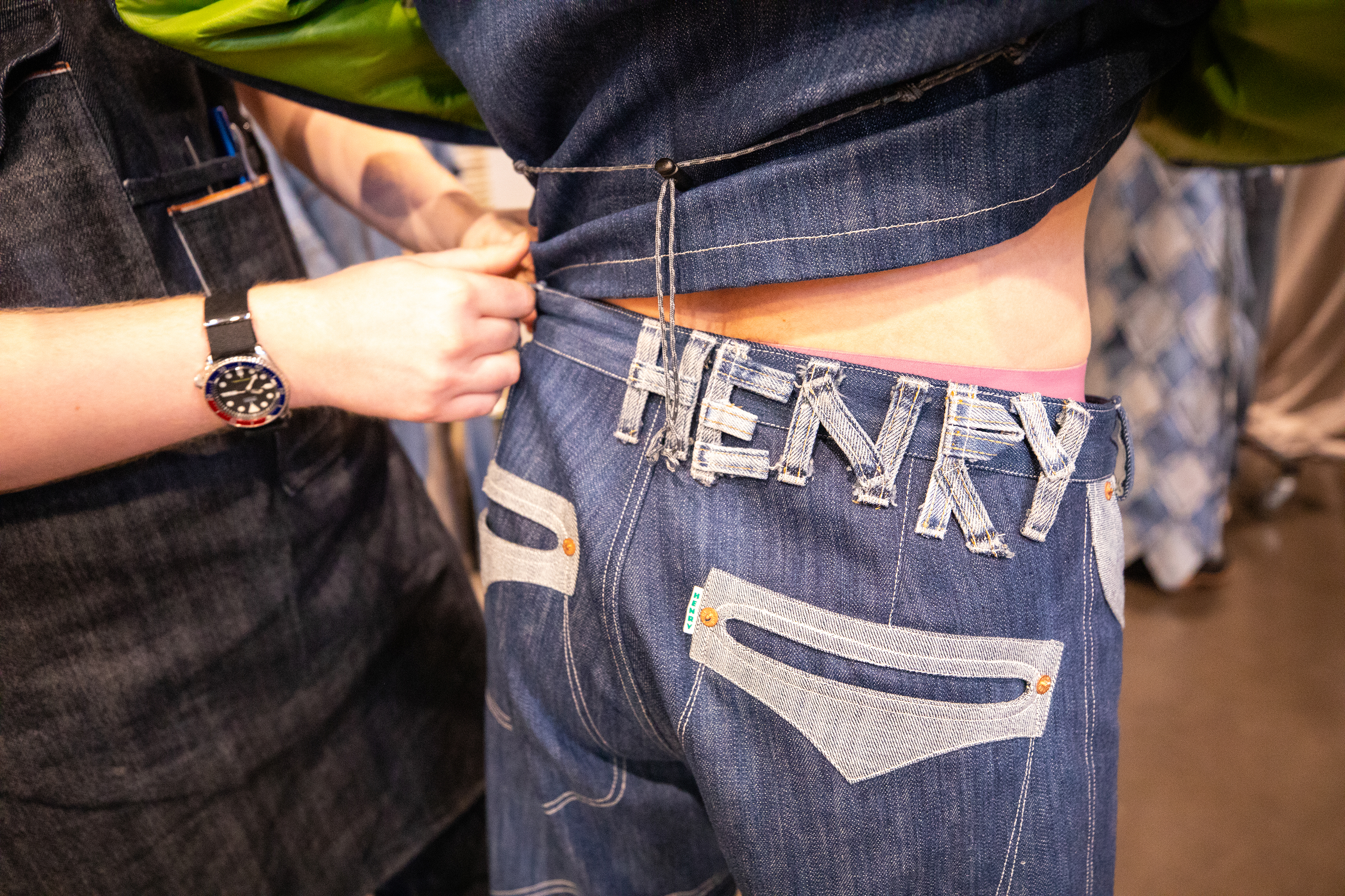 detail of pocket stiching and branding in back of jeans