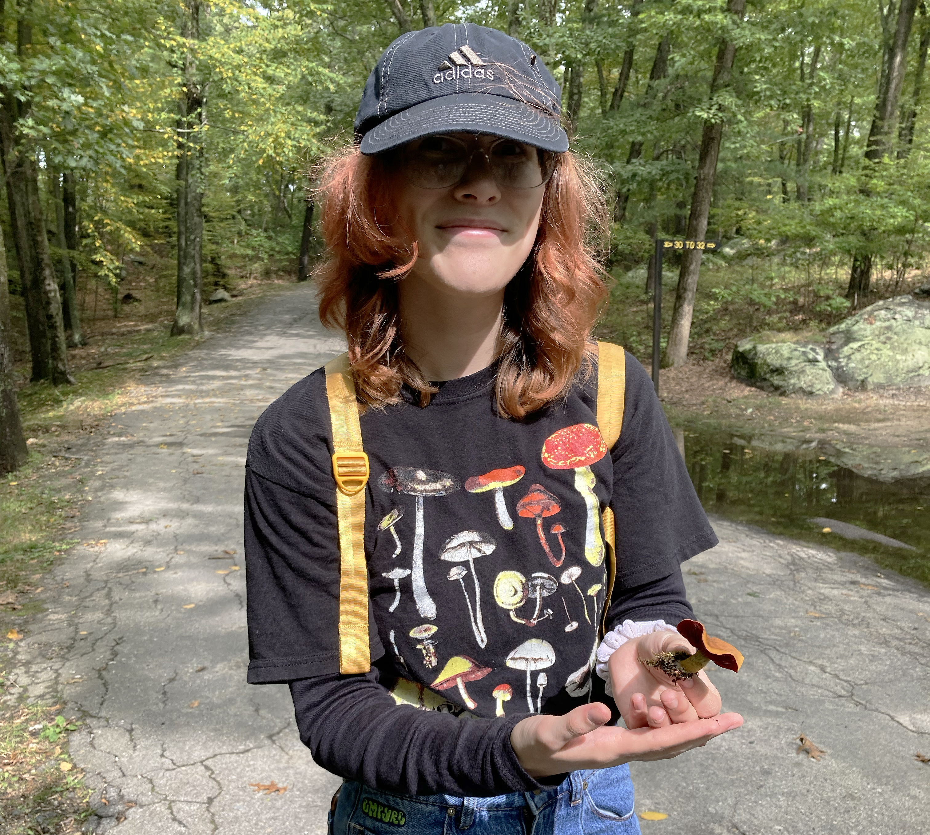 Taylor Burgess shows off a mushroom she has foraged in the woods