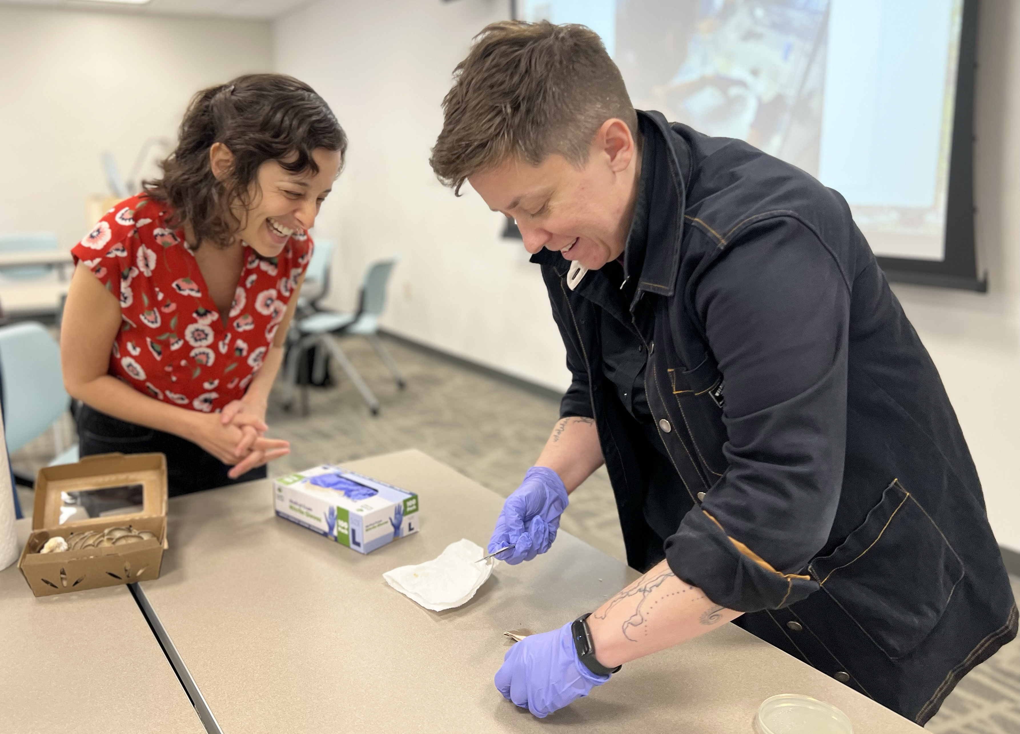 Chloe Zimmerman looks on as Jen Ansley sterilizes her scalpel