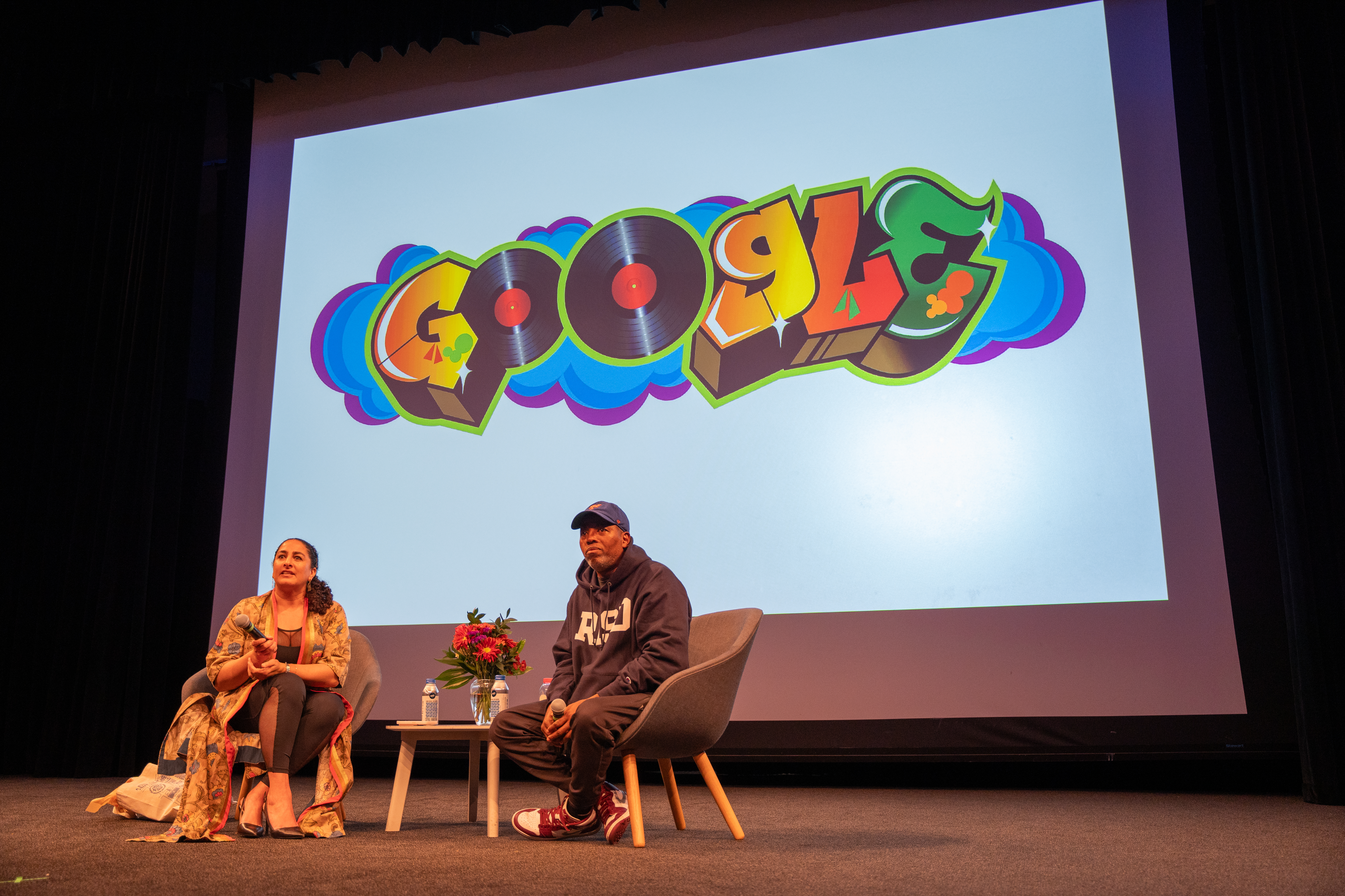RISD provist sits down on stage with Cey Adams in a Q&A