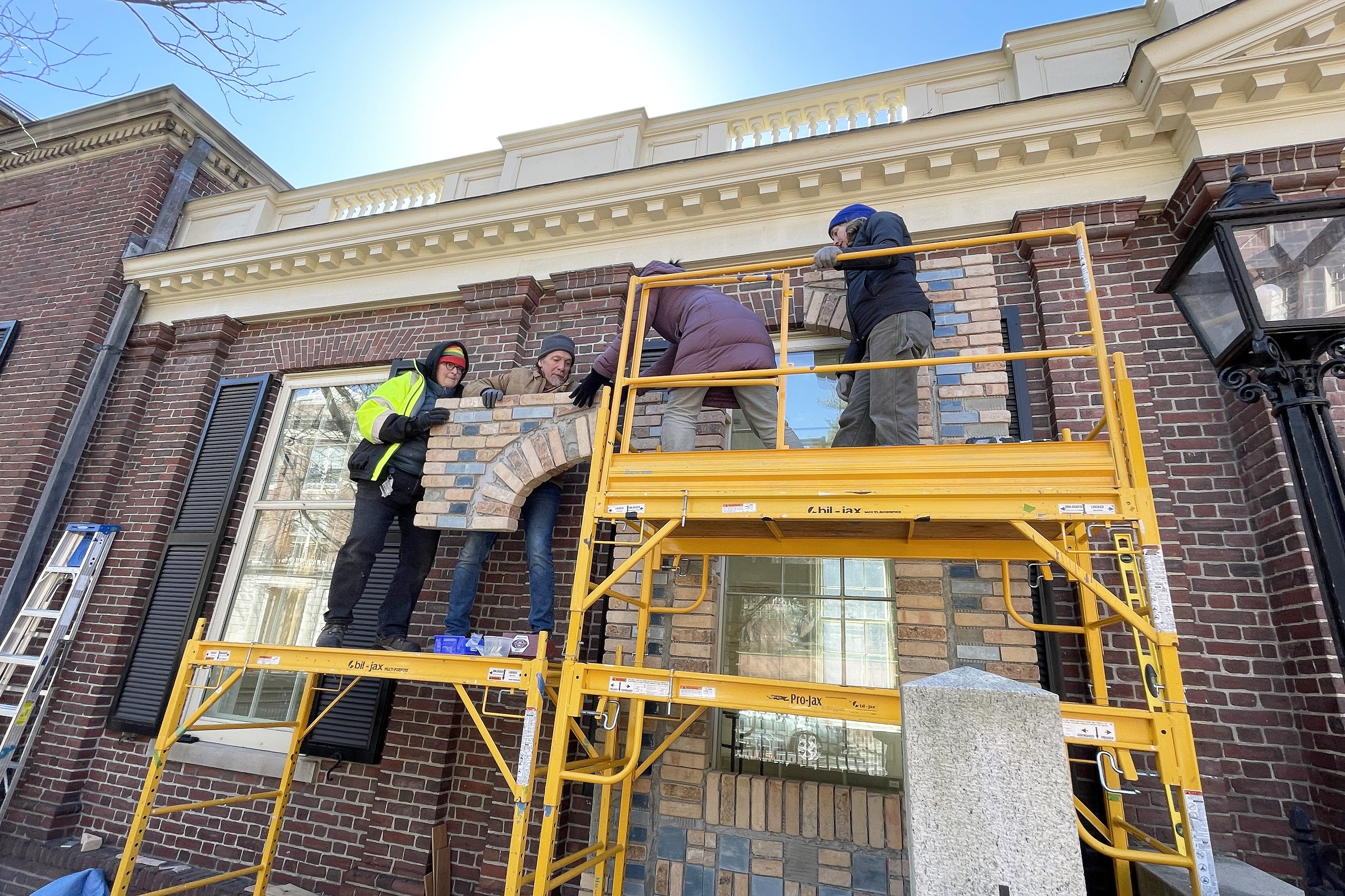 Chang works with museum installation professionals outside of the Radeke Building on large scaffolding