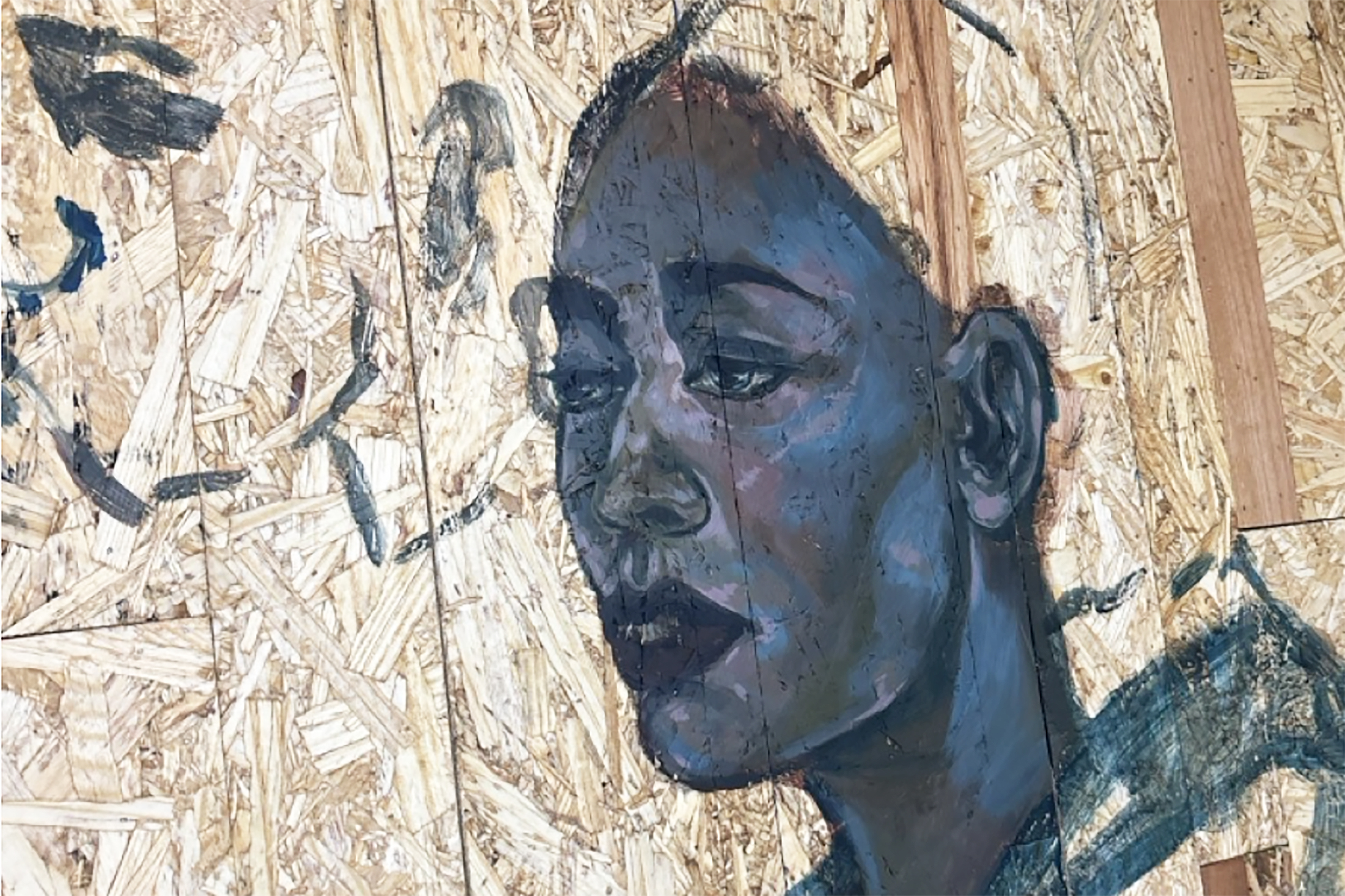 detail of a face in the painting with OSB board all around