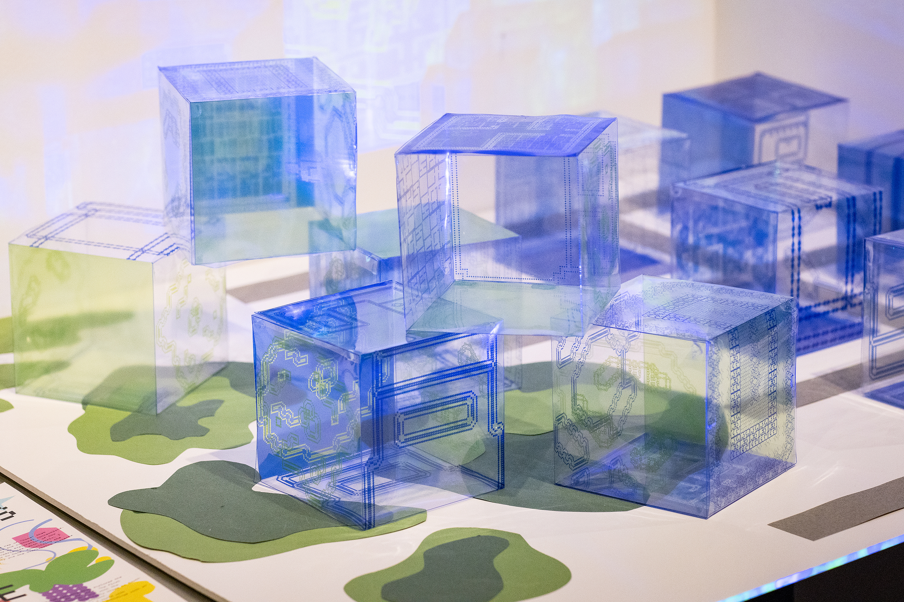 transparent blue cubes on display in a Graphic Design crit