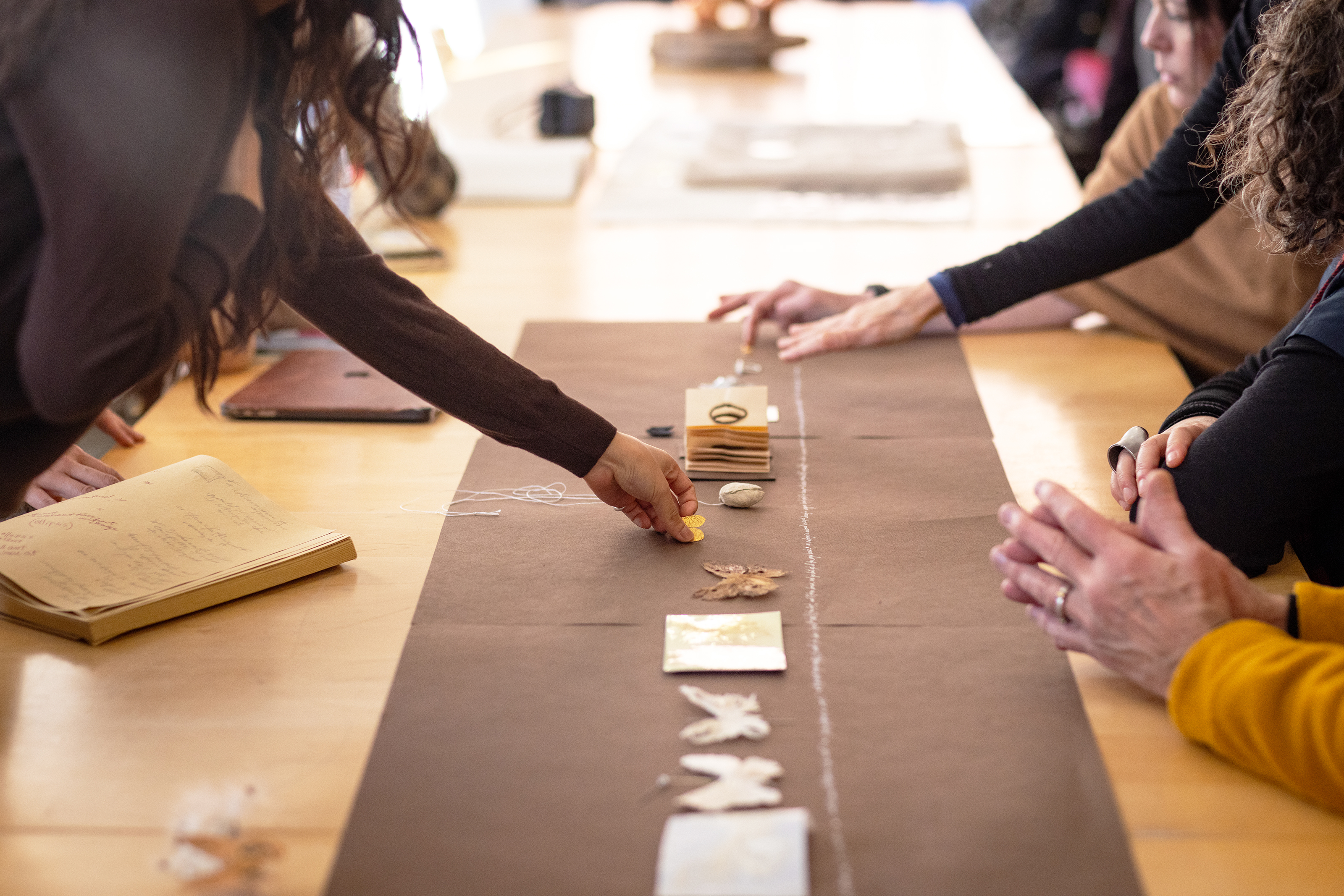 jewelry pieces by Anne Irving laid out on the table like a poem