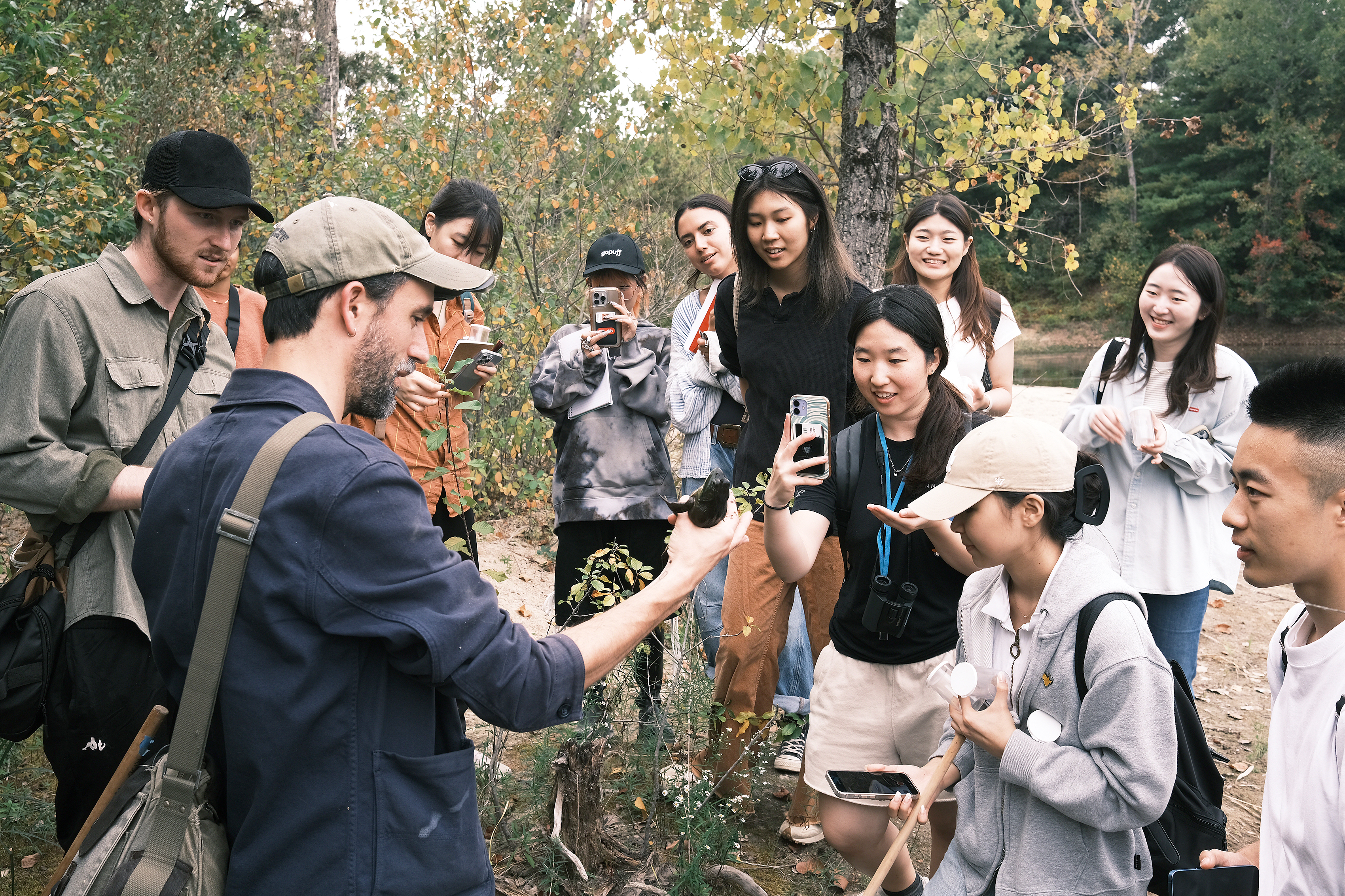 Nature Lab biologist Ben Gagliardi shows the class a bullfrog he's discovered at the Big River Management Area