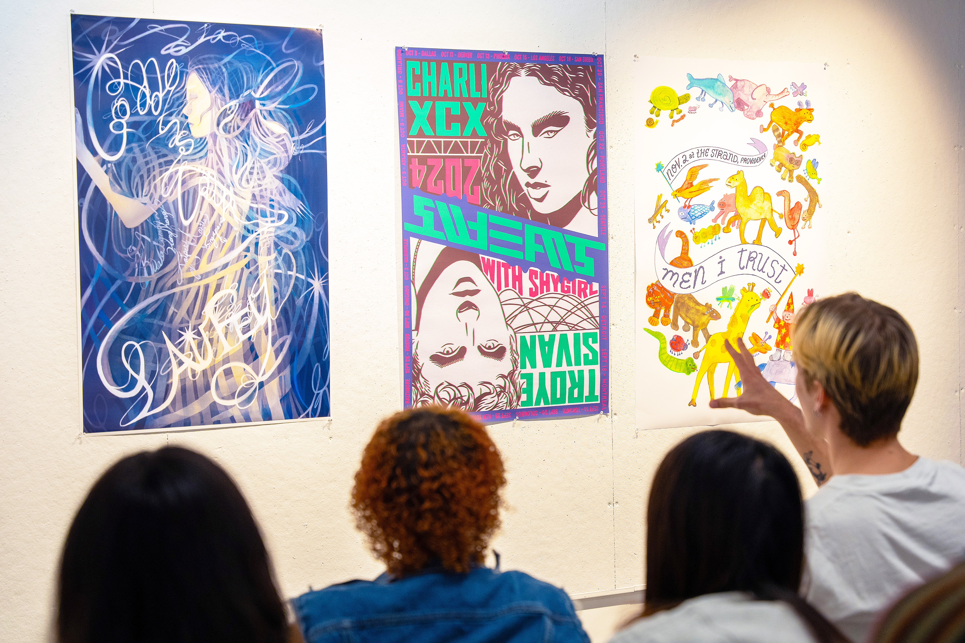students discuss gig posters at an Illustration department critique