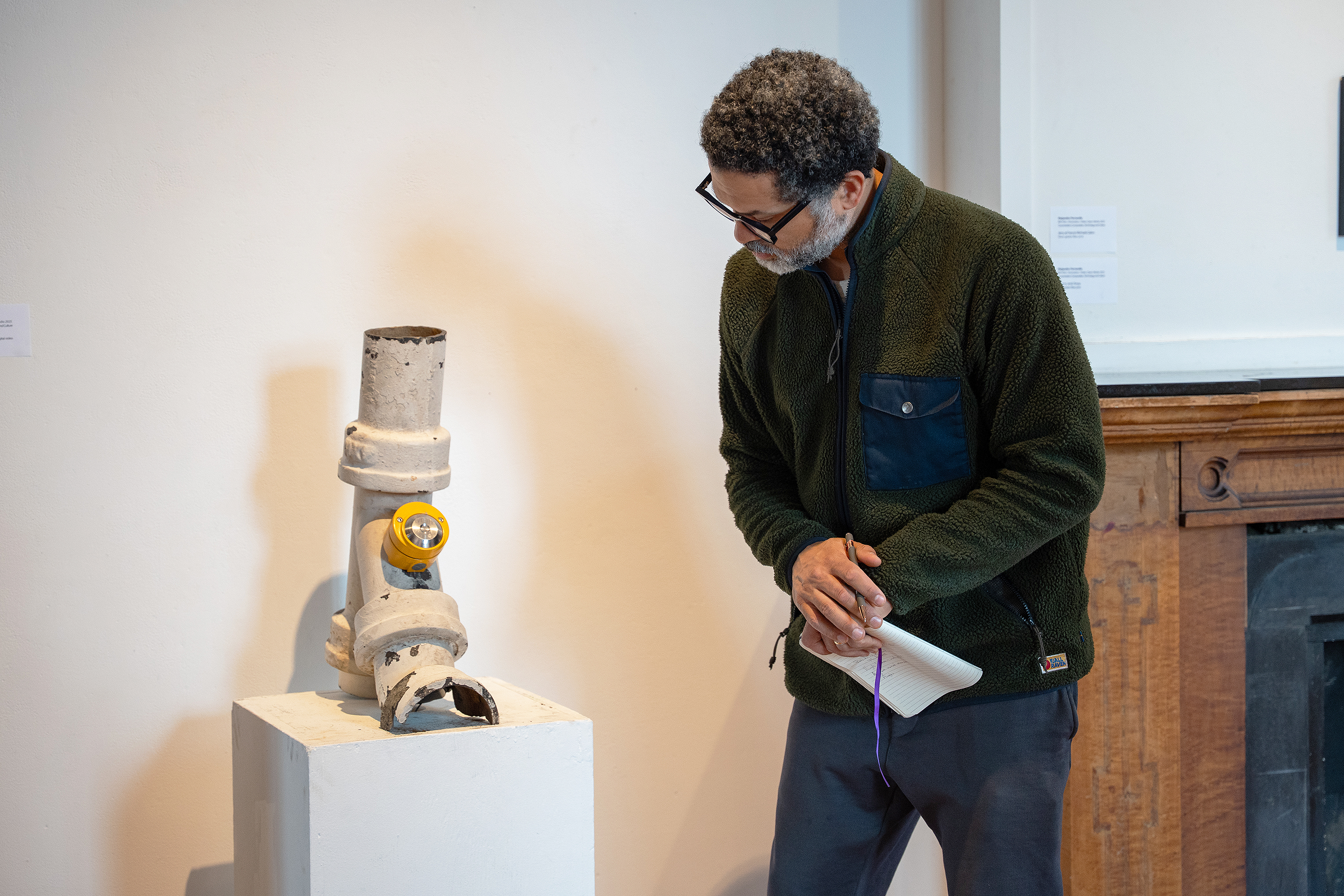 Jason Moran examines a student installation in Woods-Gerry Gallery