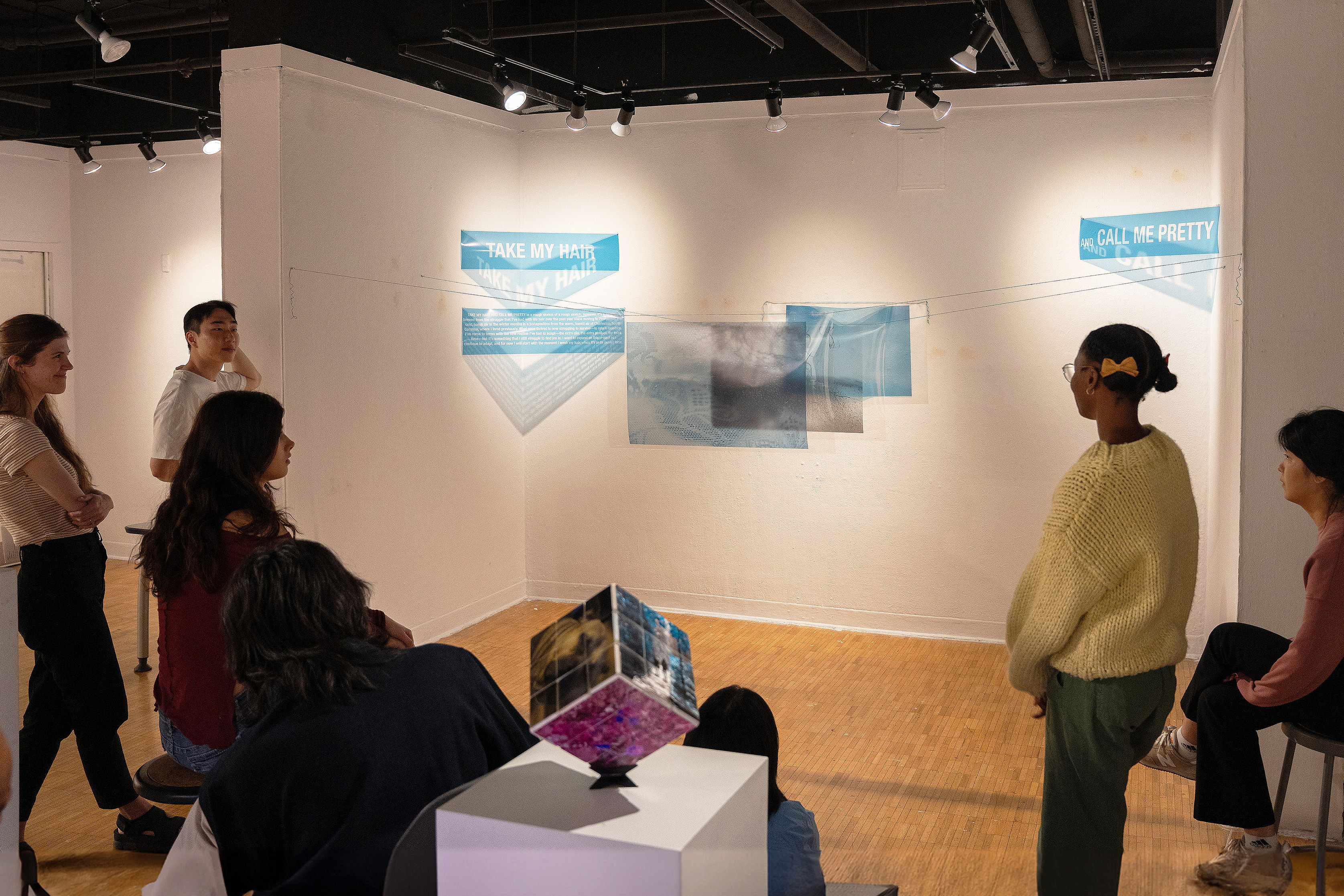 students gather around an installation in the Red Eye Gallery