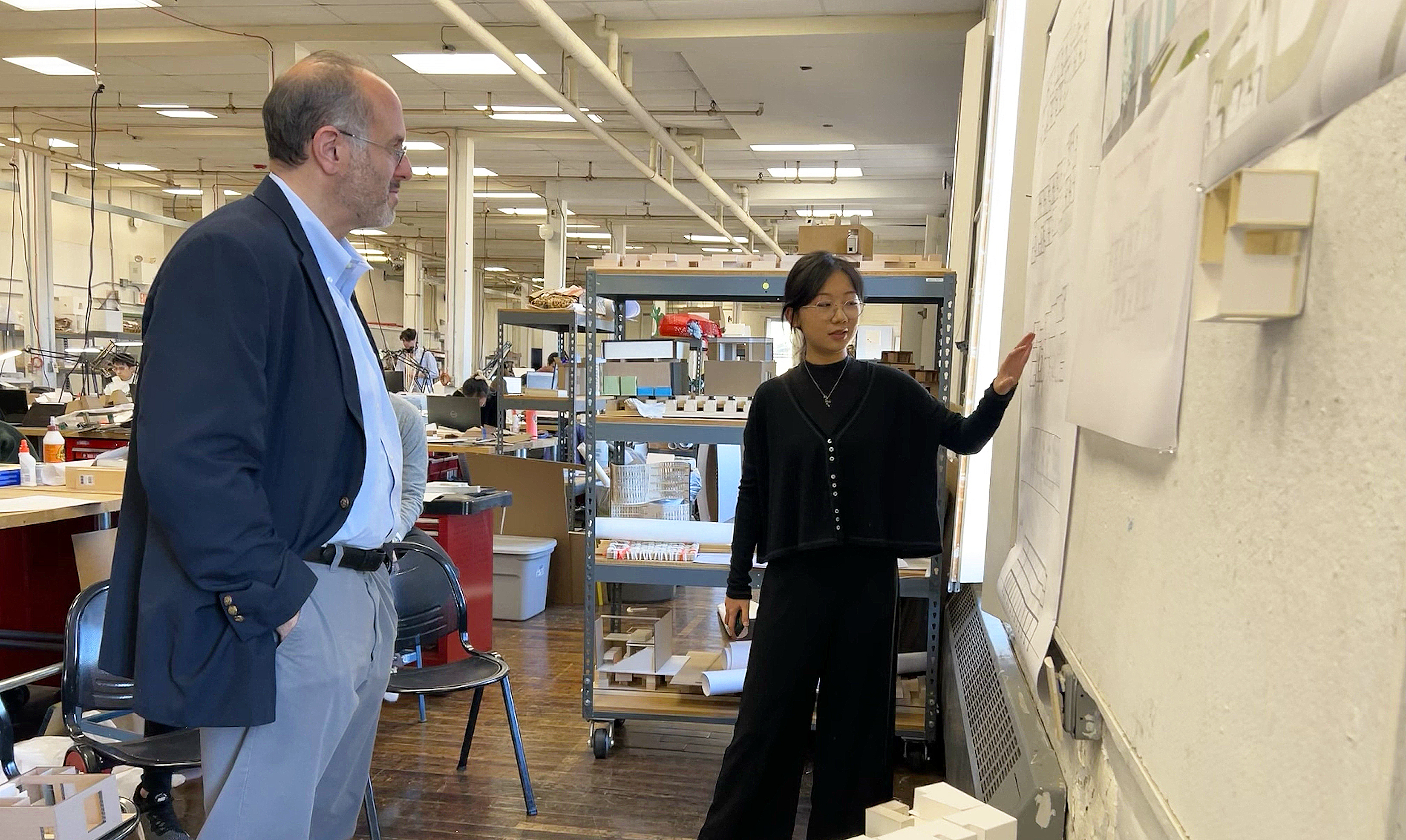 Rhode Island Secretary of Housing Stefan Pryor examines student renderings in the BEB