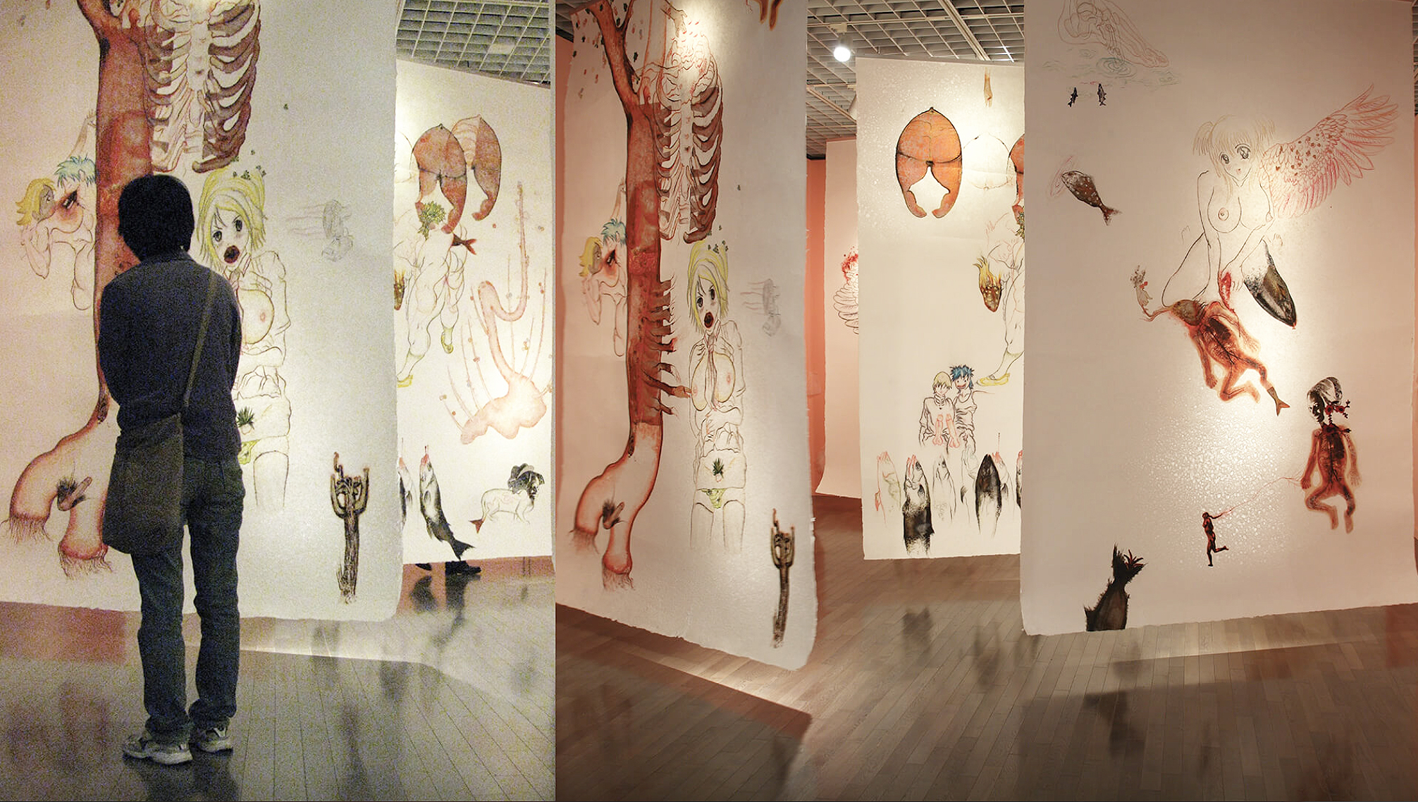 a visitor regards illustrations by Sen at a Japanese gallery