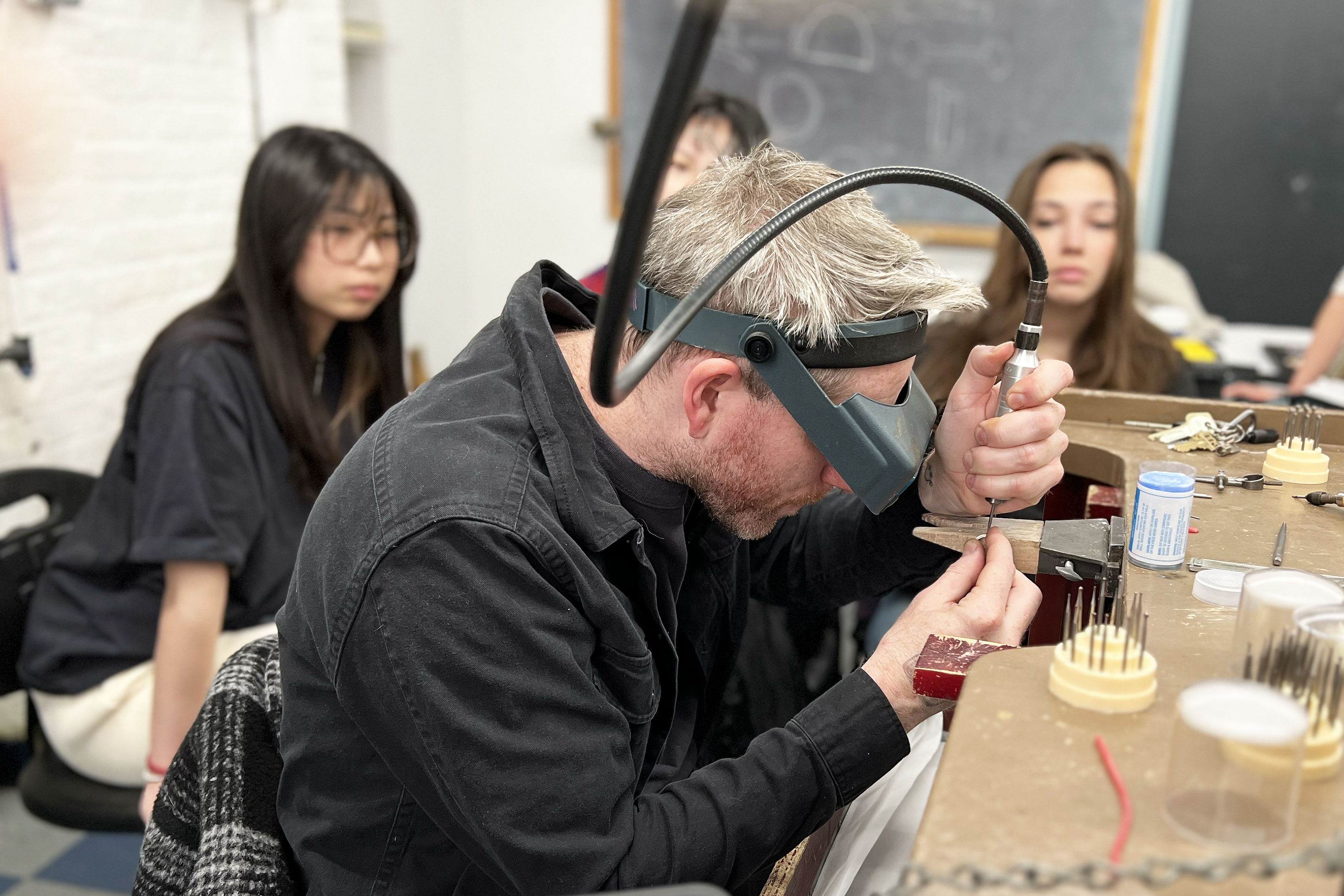 faculty member Everett Hoffman demonstrates proper stone-setting technique