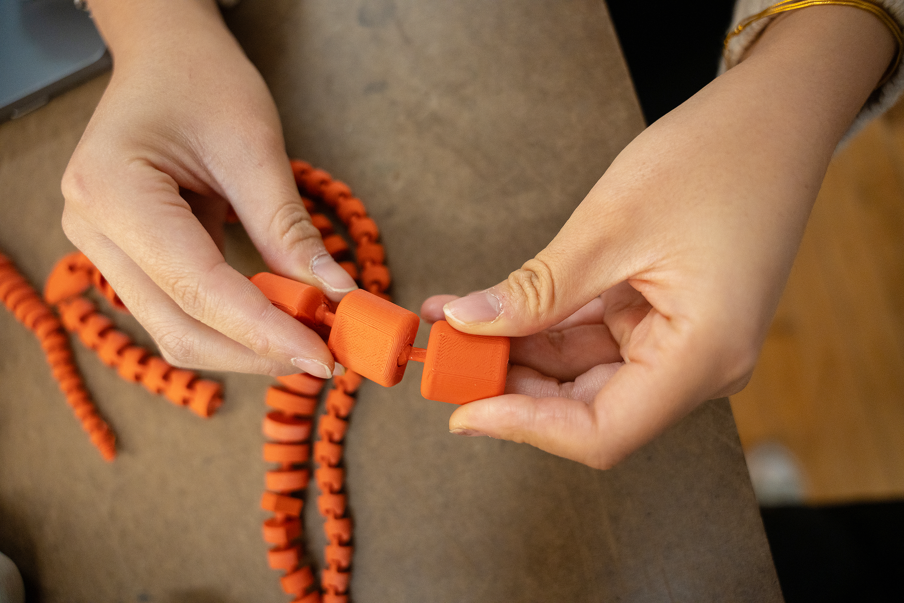 student shows a 3D-printed joint with nice flexibility