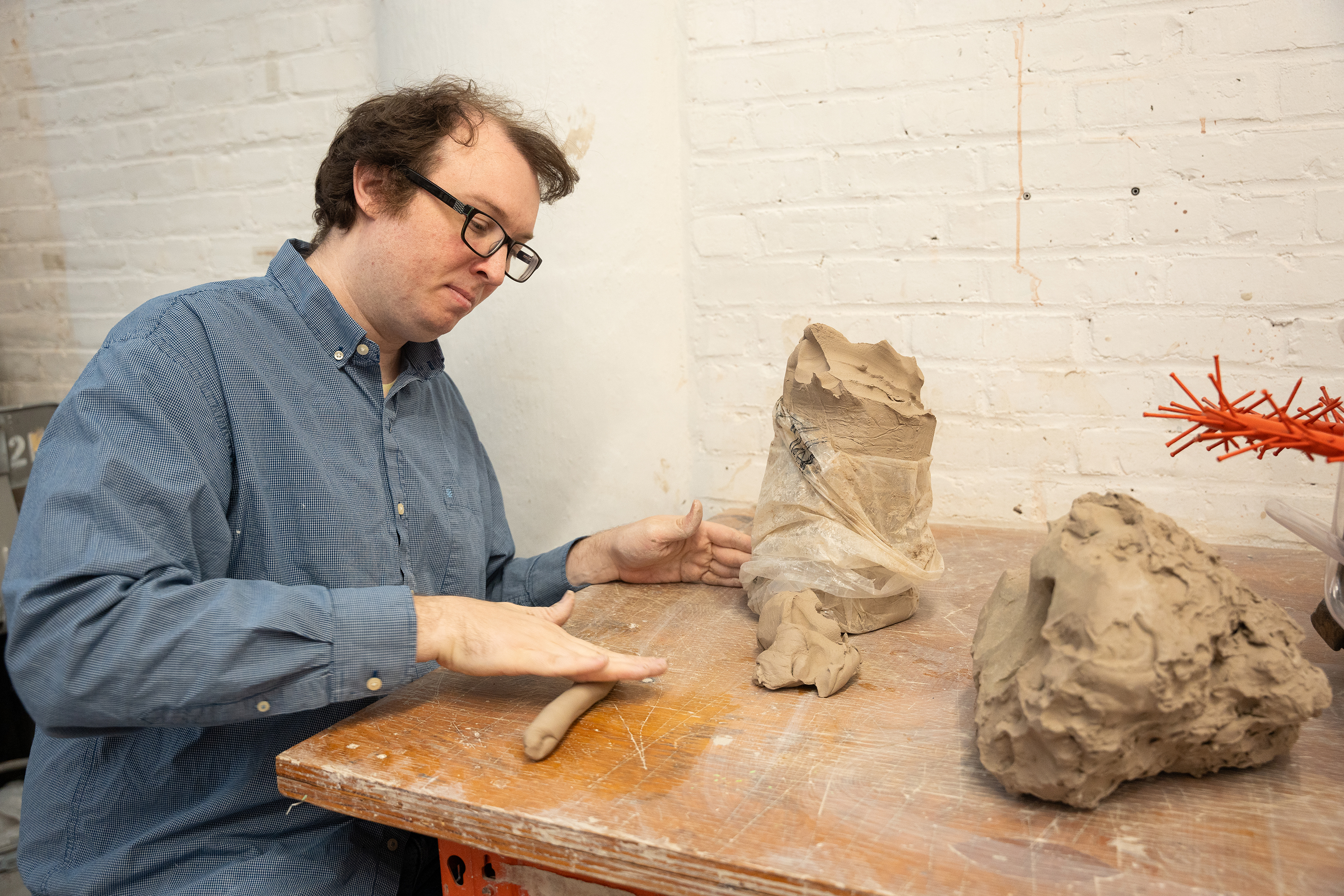 Presidential Fellow Matthew Brown rolling out clay in his studio