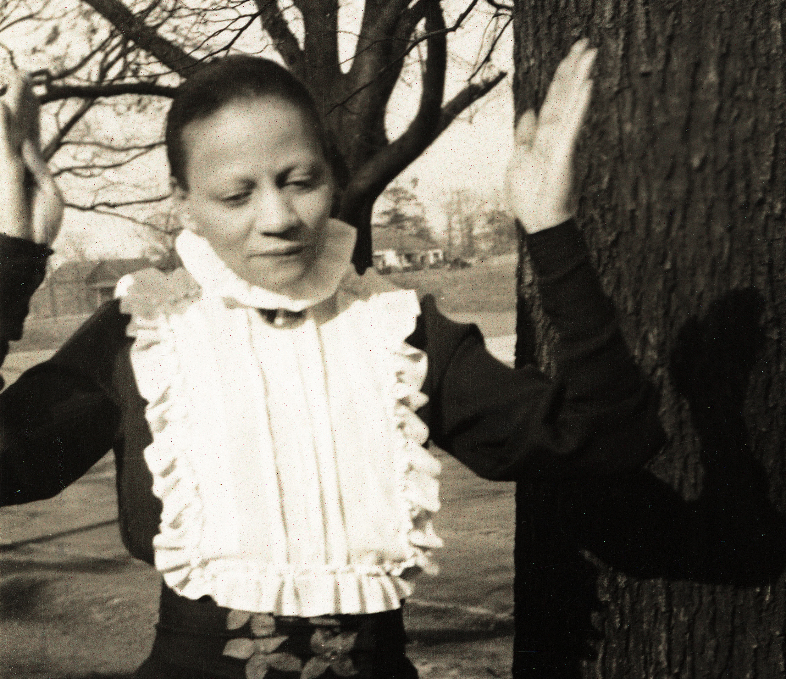 a black-and-white photo of the artist outdoors