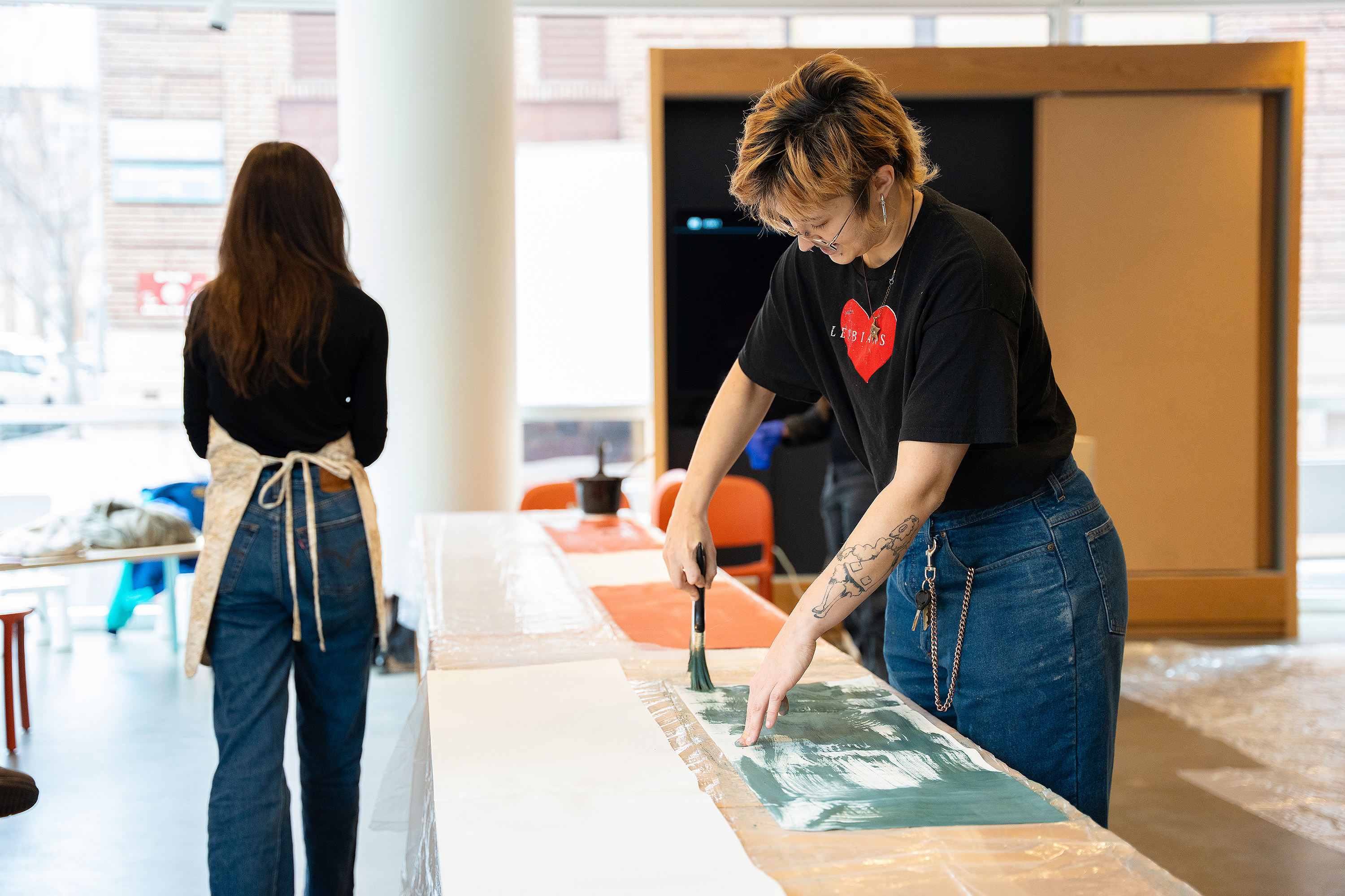 a student paints onto sturdy paper for printing